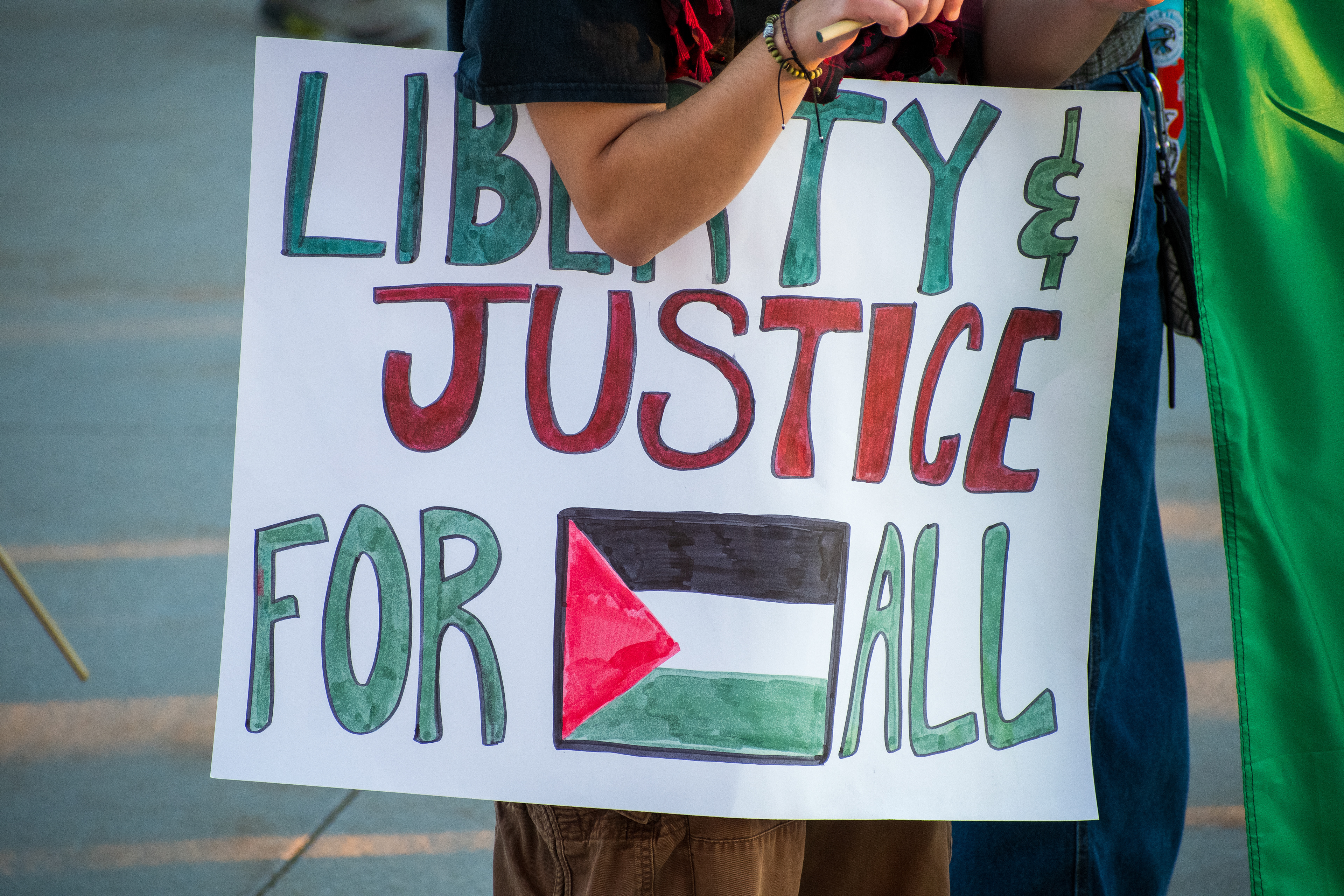 October 10, 2025, Salt Lake City, Utah, USA: A demonstrator holds a sign featuring symbolic colors and imagery during the Free Palestine Rally at the Utah State Capitol. The participant stands on a paved surface while partially obscured by the sign. (Credit Image: © Charles-McClintock Wilson/ZUMA Press Wire)