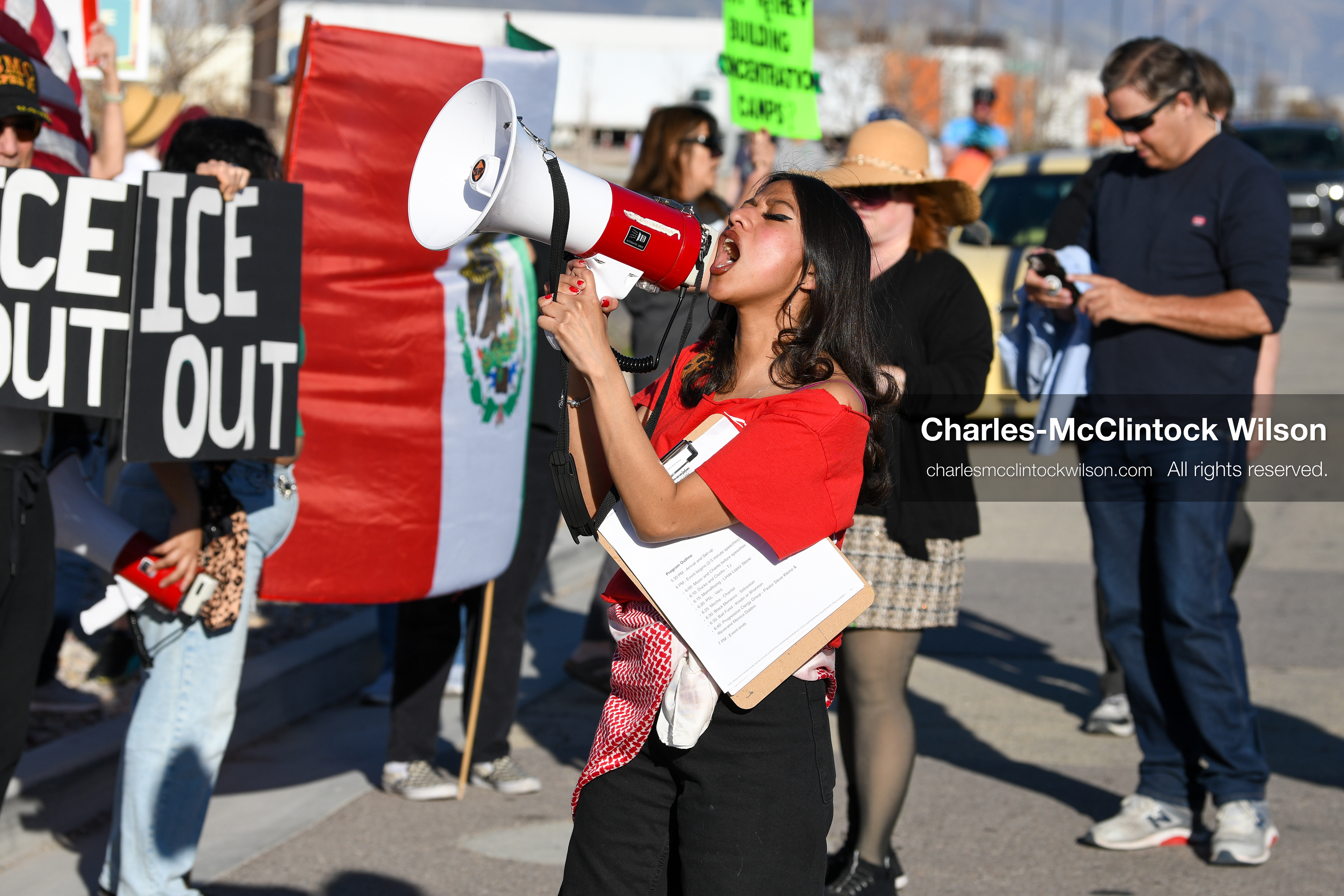 March 18, 2026, Salt Lake City, Utah, USA: A protester speaks through a megaphone as people gather with signs and flags during a demonstration at the site of a proposed ICE detention facility on the west side of Salt Lake City. The gathering took place near the warehouse property as part of a community response to the planned use of the location. (Credit Image: © Charles McClintock Wilson/ZUMA Press Wire)