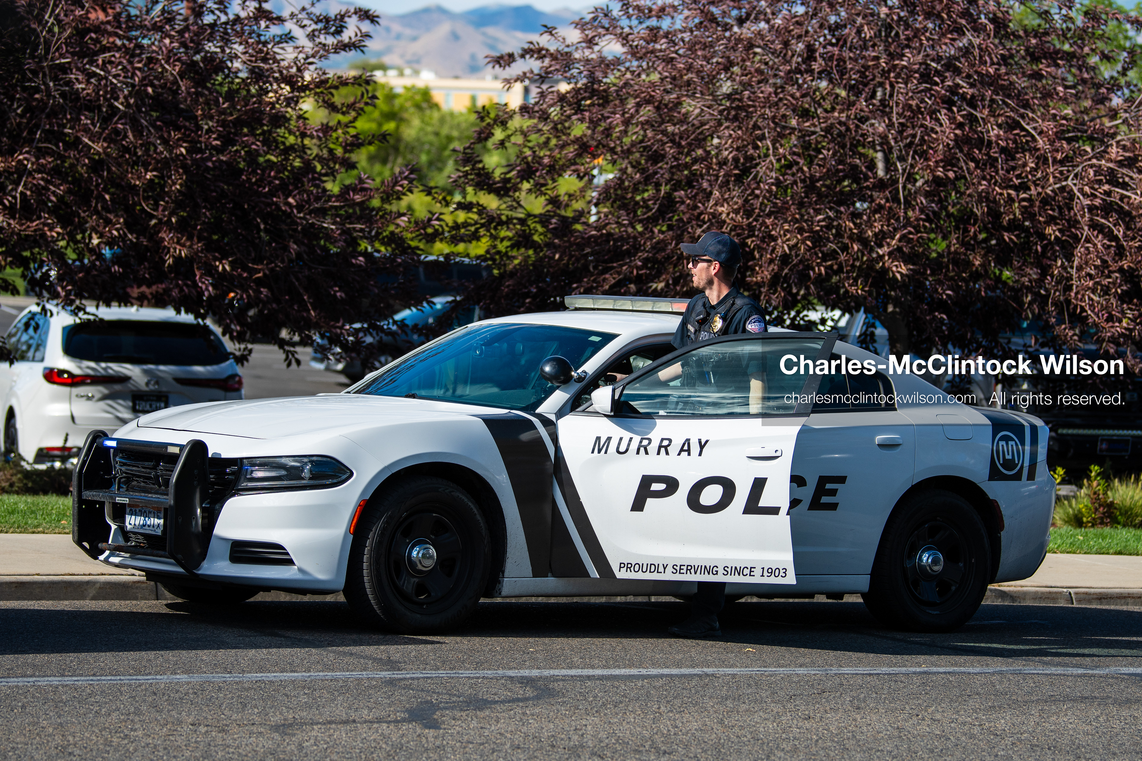 August 17, 2026, Murray, Utah, USA: A Murray City Police officer stands behind the open driver-side door of a marked police cruiser parked outside Intermountain Medical Center on Monday. Multiple police agencies secured the hospital perimeter as a safety precaution after shooting victims were brought in from a fatal shootout outside a funeral in nearby Kearns. (Credit Image: © Charles McClintock Wilson/ZUMA Press Wire)