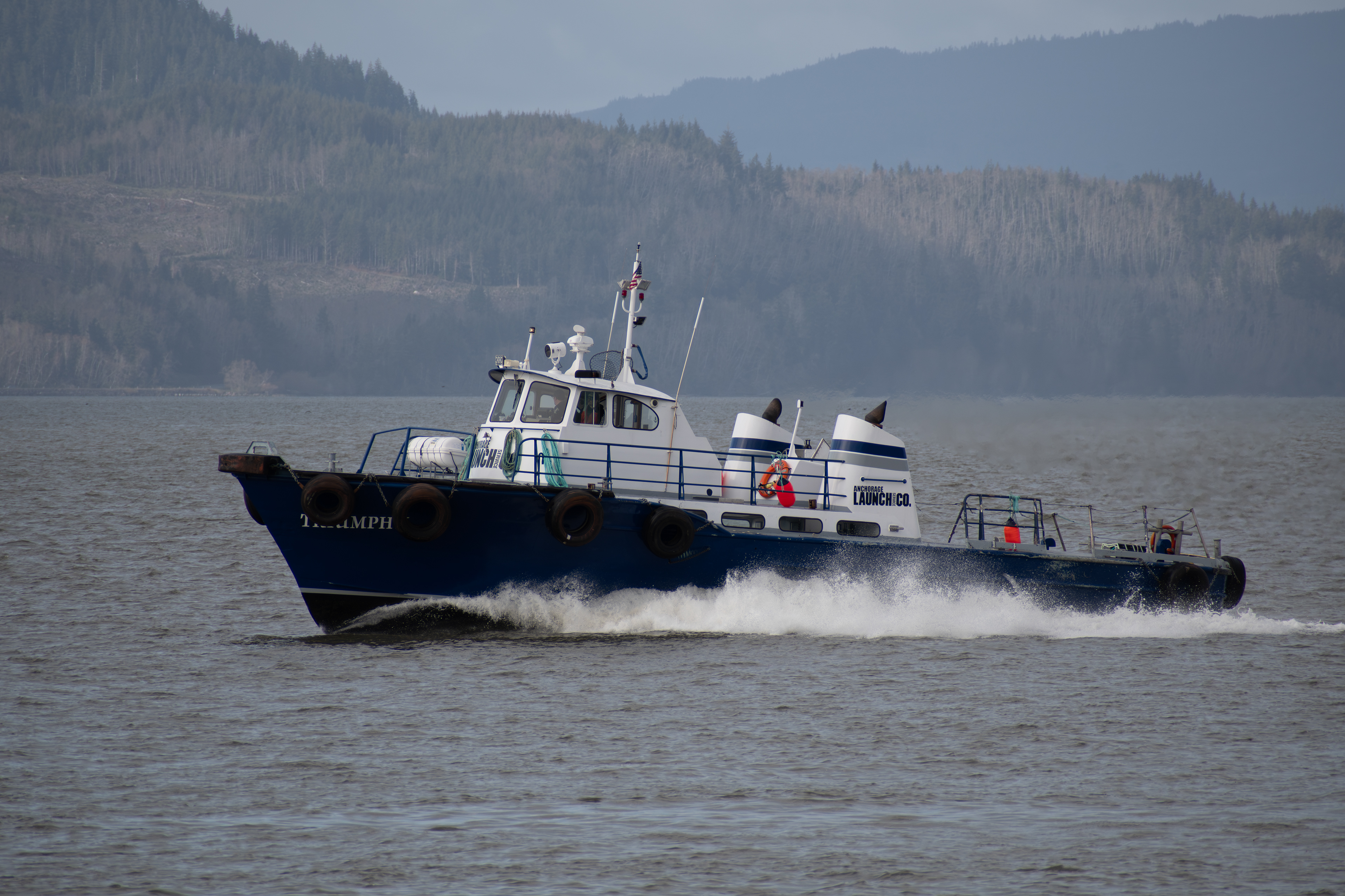 ASTORIA, OR, USA – APRIL 10: The Metal Shark vessel Triumph II, bearing markings for Anchorage Launch Services Co., travels on the Columbia River near the Port of Astoria in Oregon on April 10, 2025.