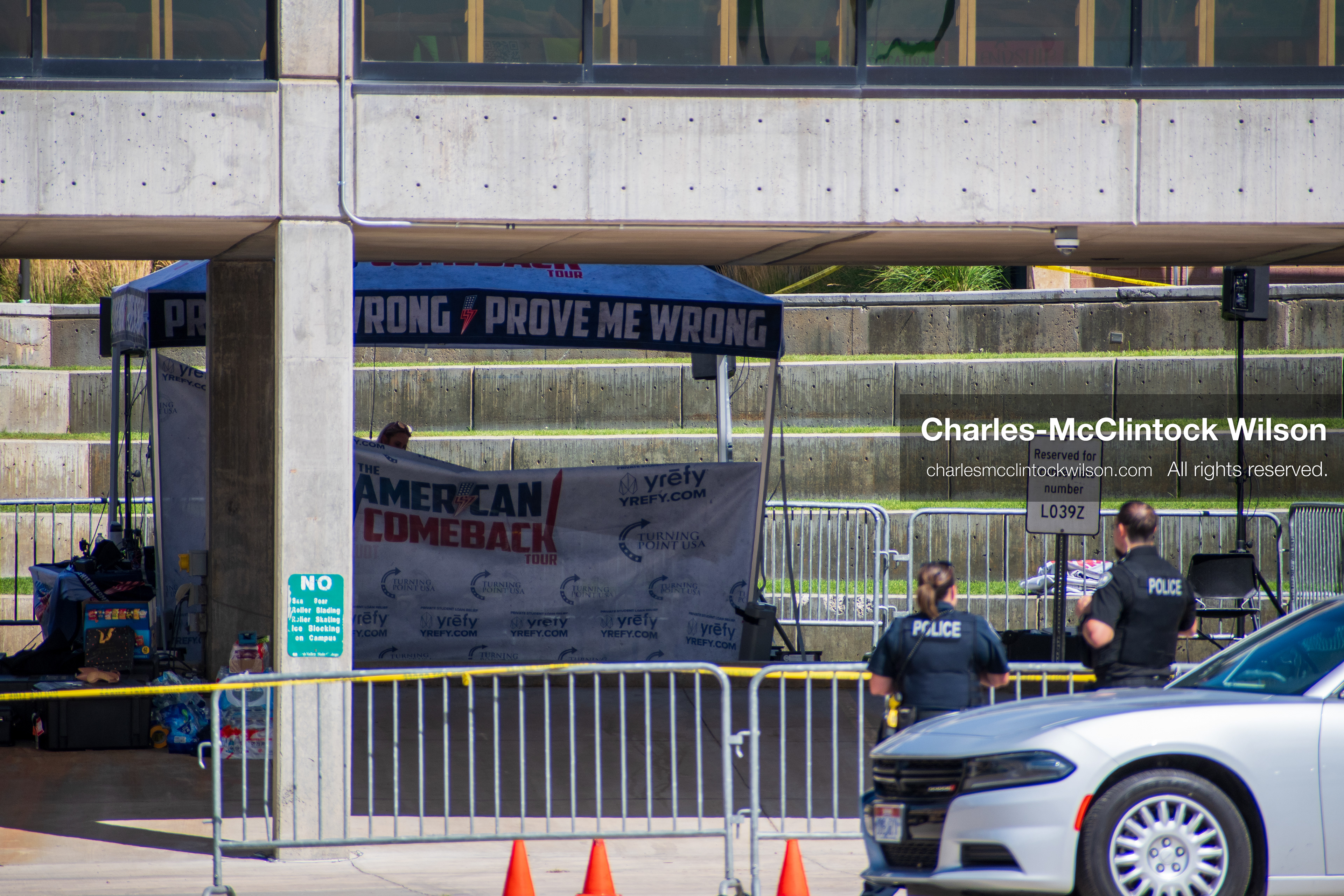 September 12, 2025, Orem, Utah, USA: Investigators and police officers secure the canopy-covered courtyard at Utah Valley University in Orem, Utah, where conservative activist CHARLIE KIRK was fatally shot during a public speaking event on September 10, 2025. KIRK, CEO of Turning Point USA, was seated beneath the canopy when a single bullet struck him in the neck.   (Credit Image: © Charles‑McClintock Wilson/ZUMA Press Wire)