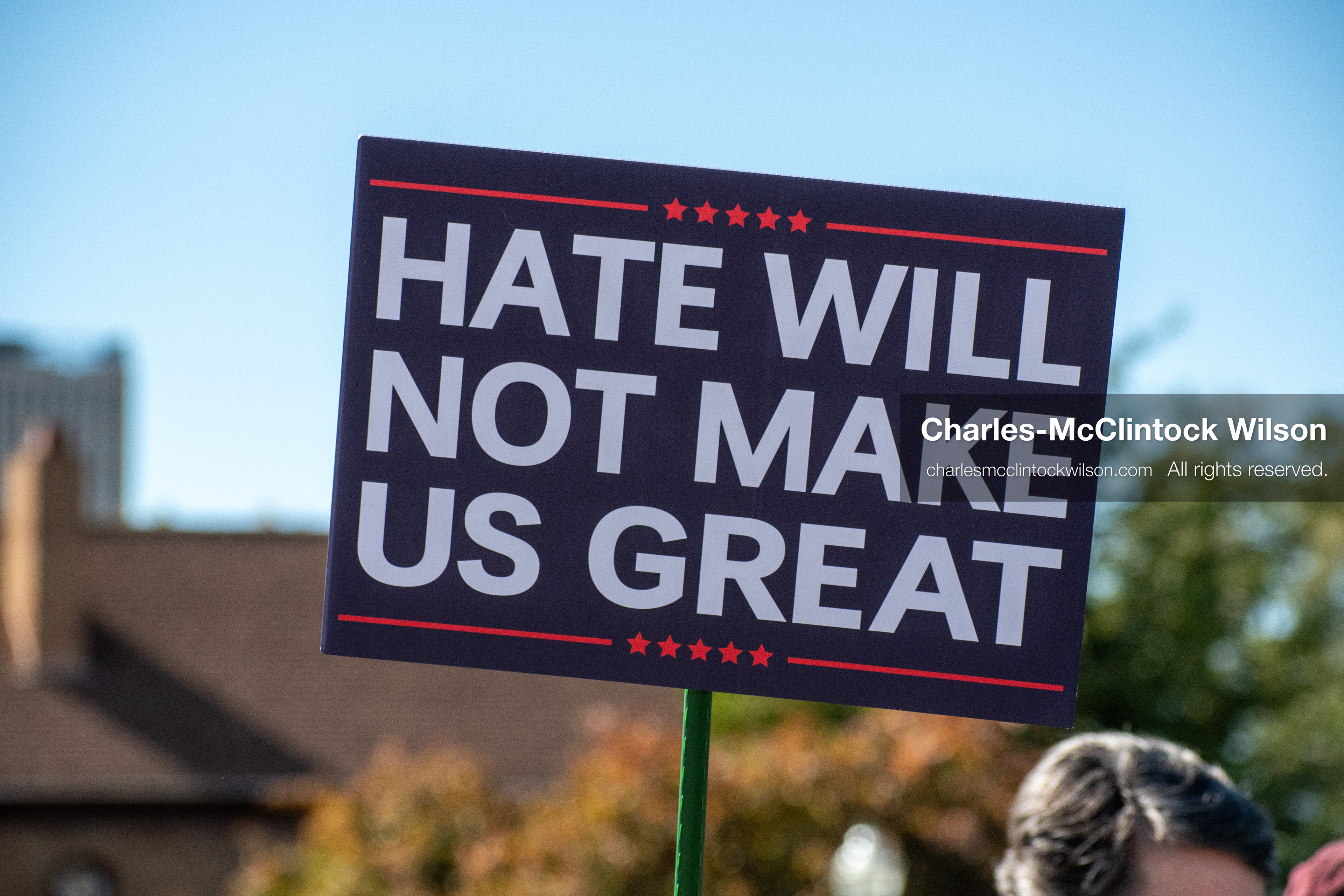 October 18, 2025, Salt Lake City, Utah, USA: A demonstrator raises a placard during a "No Kings" protest held at the Utah State Capitol. Other participants and signs are visible in the background during the public gathering.