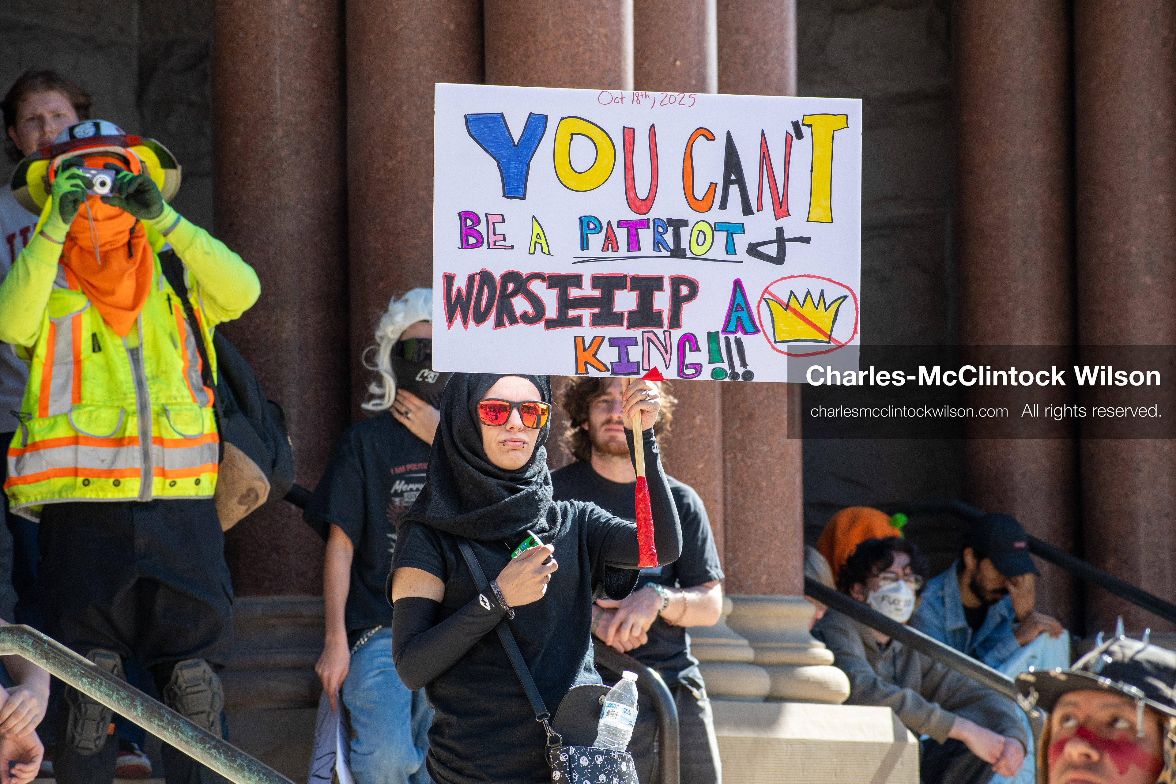 October 18, 2025, Salt Lake City, Utah, USA: A demonstrator holds a colorful protest sign during a "No Kings" rally at Washington Square Park in Salt Lake City, Utah. The protest was part of a nationwide mobilization.