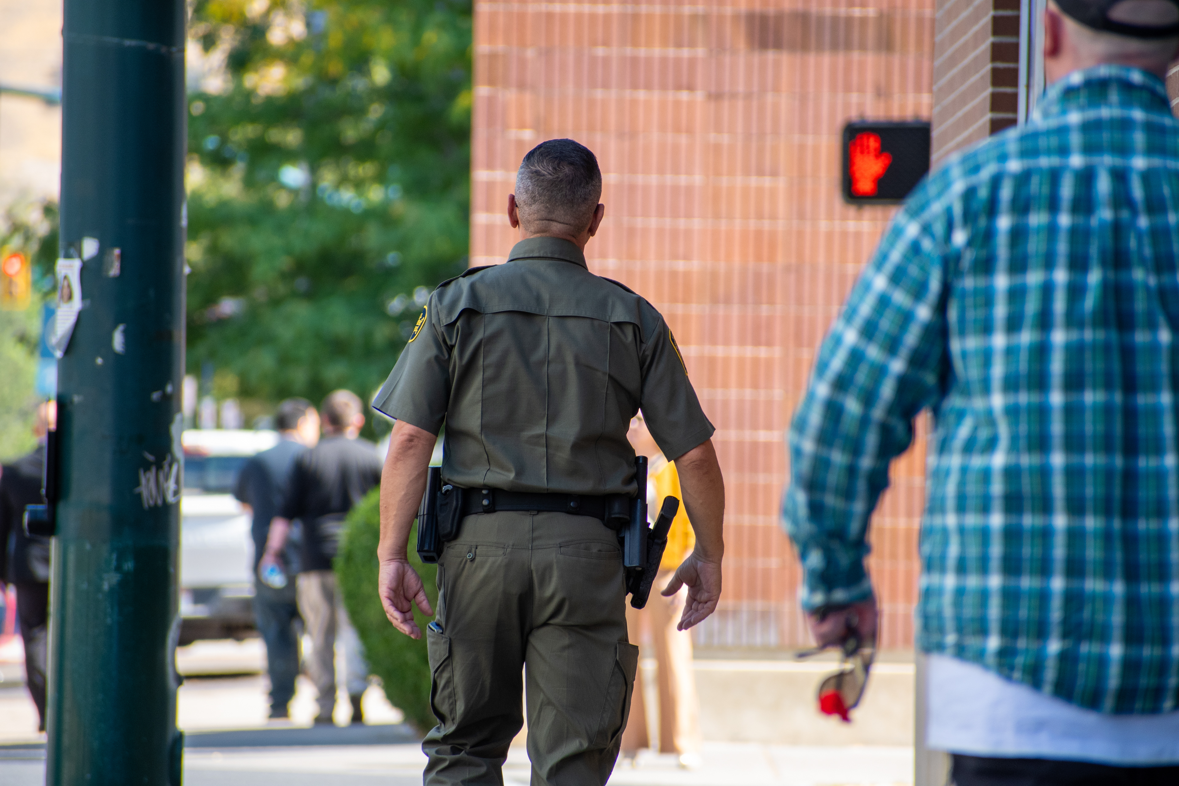 A U.S. Border Patrol agent walks near the Utah Valley Convention Center during a Department of Homeland Security career expo focused on recruiting law enforcement and security personnel. Photograph by Charles‑McClintock Wilson / ZUMA Press Wire