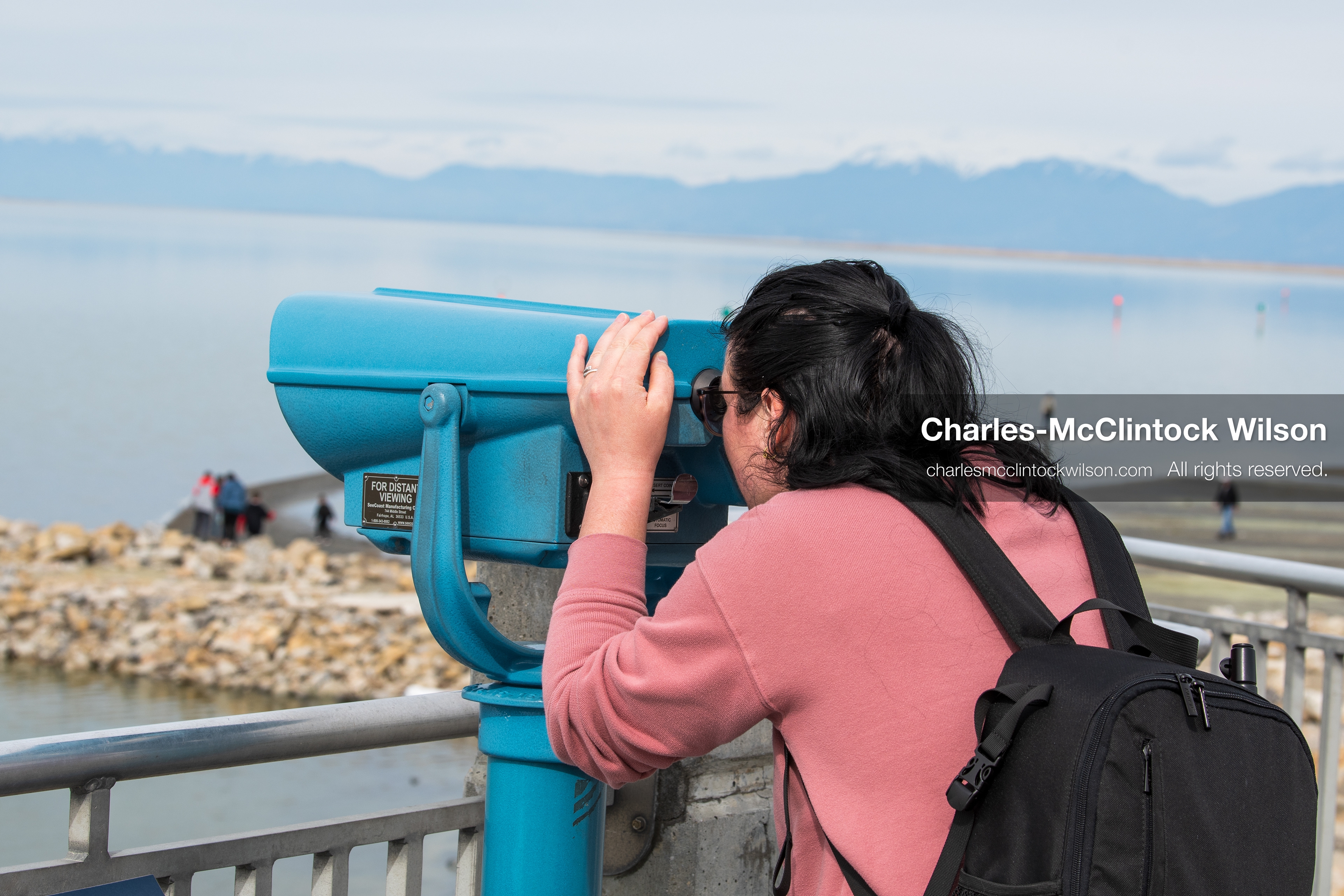 March 1, 2026, Great Salt Lake, Utah, USA: A person looks through a viewer toward the Great Salt Lake as others stand on a rocky jetty in the distance. The region continues to experience historically low water levels. Reports from state officials and the Great Salt Lake Strike Team state that the lake remains in a serious adverse‑effects range, with elevations among the lowest recorded in more than one hundred years. The lake has drawn increased public attention as lawmakers consider large‑scale water projects and long‑term plans to address declining conditions. (Credit Image: © Charles‑McClintock Wilson/ZUMA Press Wire)