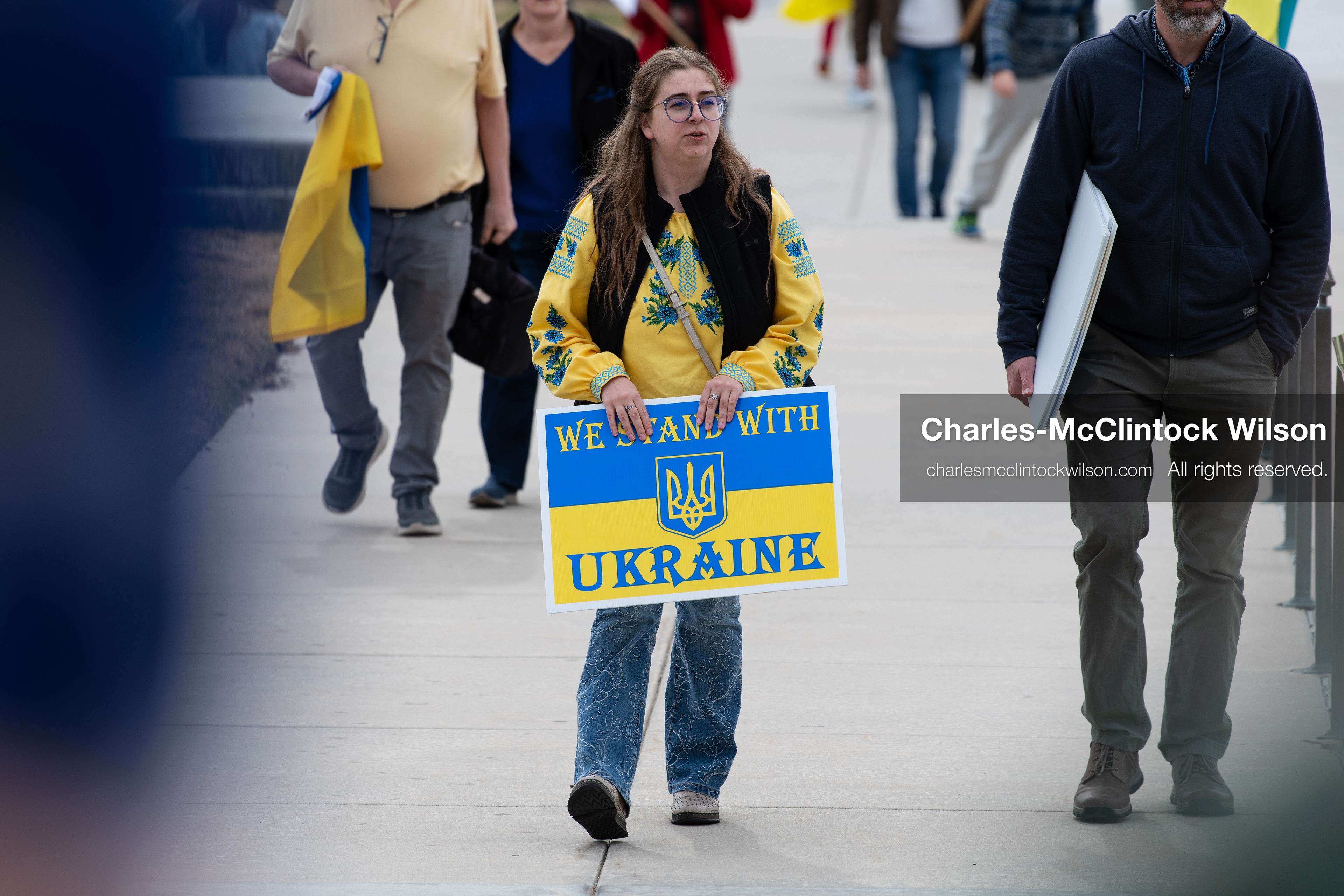 February 28, 2026, Salt Lake City, Utah, USA: A marcher wearing blue and yellow walks with a group near the Utah State Capitol during the Stand With Ukraine rally. The gathering marked the four year anniversary of the full scale Russian invasion of Ukraine and brought community members together in support of Ukrainians and local humanitarian efforts. (Credit Image: © Charles McClintock Wilson/ZUMA Press Wire)