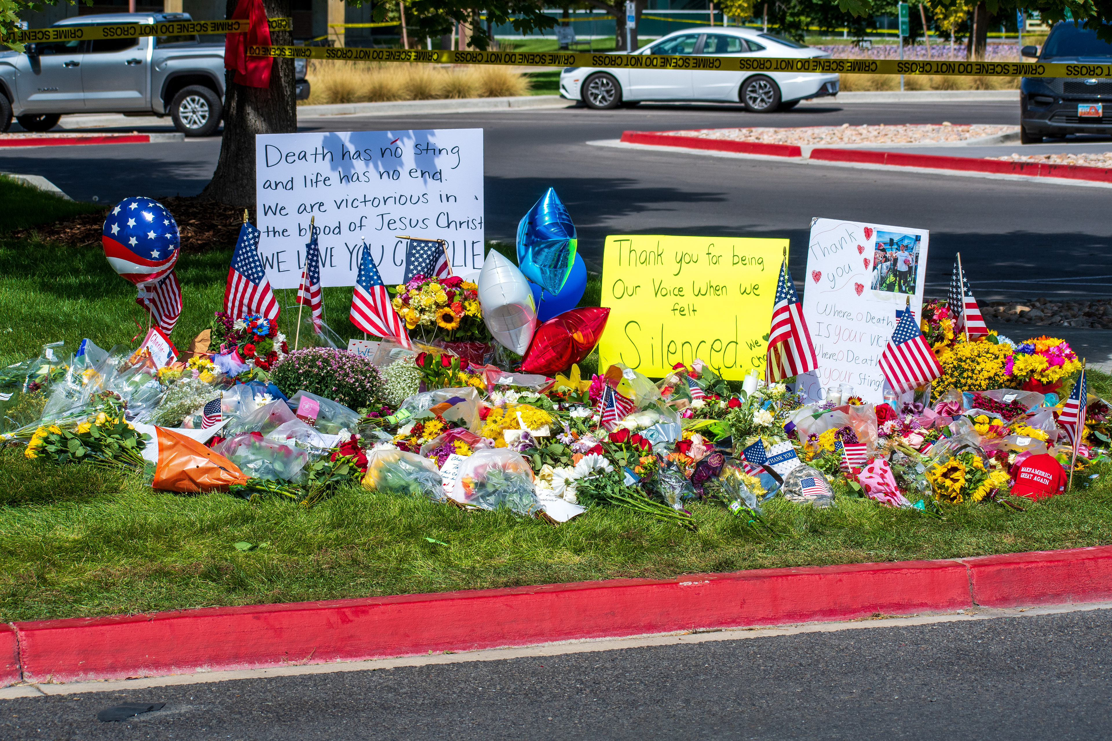 OREM, UTAH – SEPTEMBER 12, 2025: Flowers, American flags, balloons, and handwritten posters are arranged on a grassy memorial site for Charlie Kirk near Utah Valley University. The tribute reflects a collective expression of remembrance and community solidarity. © Charles‑McClintock Wilson / ZUMA Press