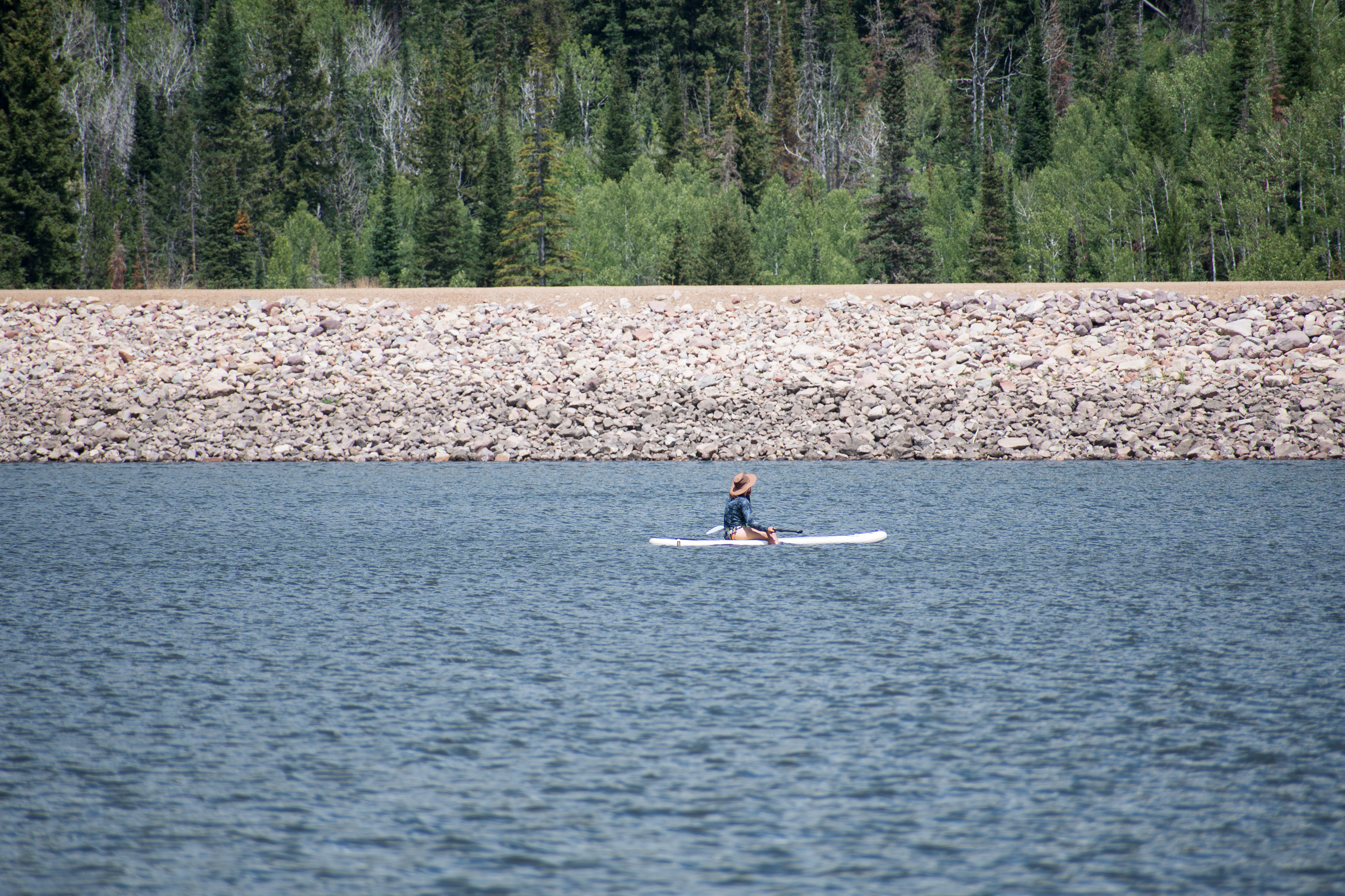 Summit County, Utah – July 20, 2025: A woman paddleboards across the water at Smith and Morehouse Reservoir. 