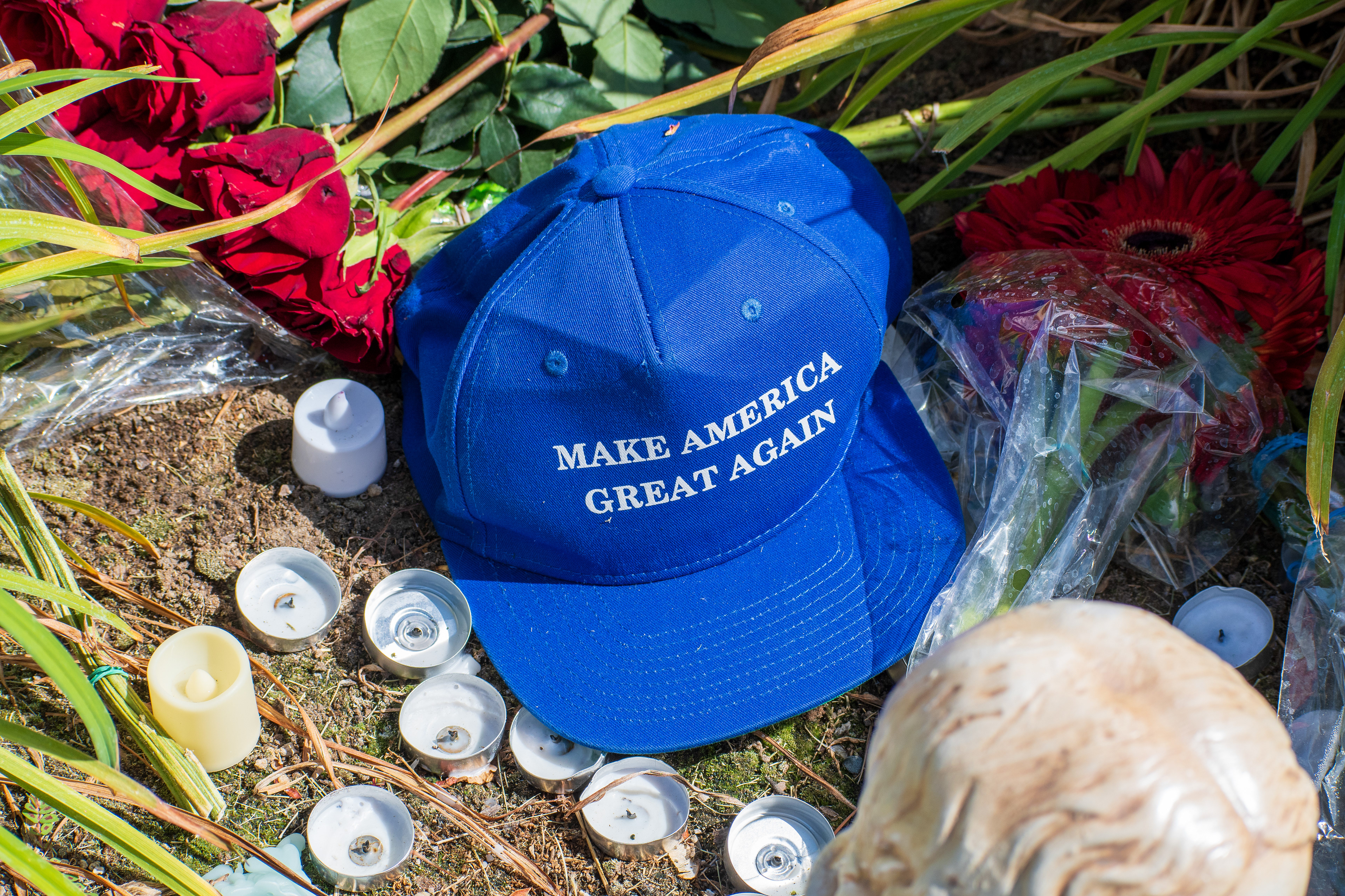 OREM, UTAH – SEPTEMBER 12, 2025: A blue “Make America Great Again” hat is displayed at a memorial site for Charlie Kirk outside Timpanogos Regional Hospital. Surrounded by red roses, white candles, and wrapped flowers, the tribute reflects a blend of political symbolism and personal remembrance. © Charles‑McClintock Wilson / ZUMA Press