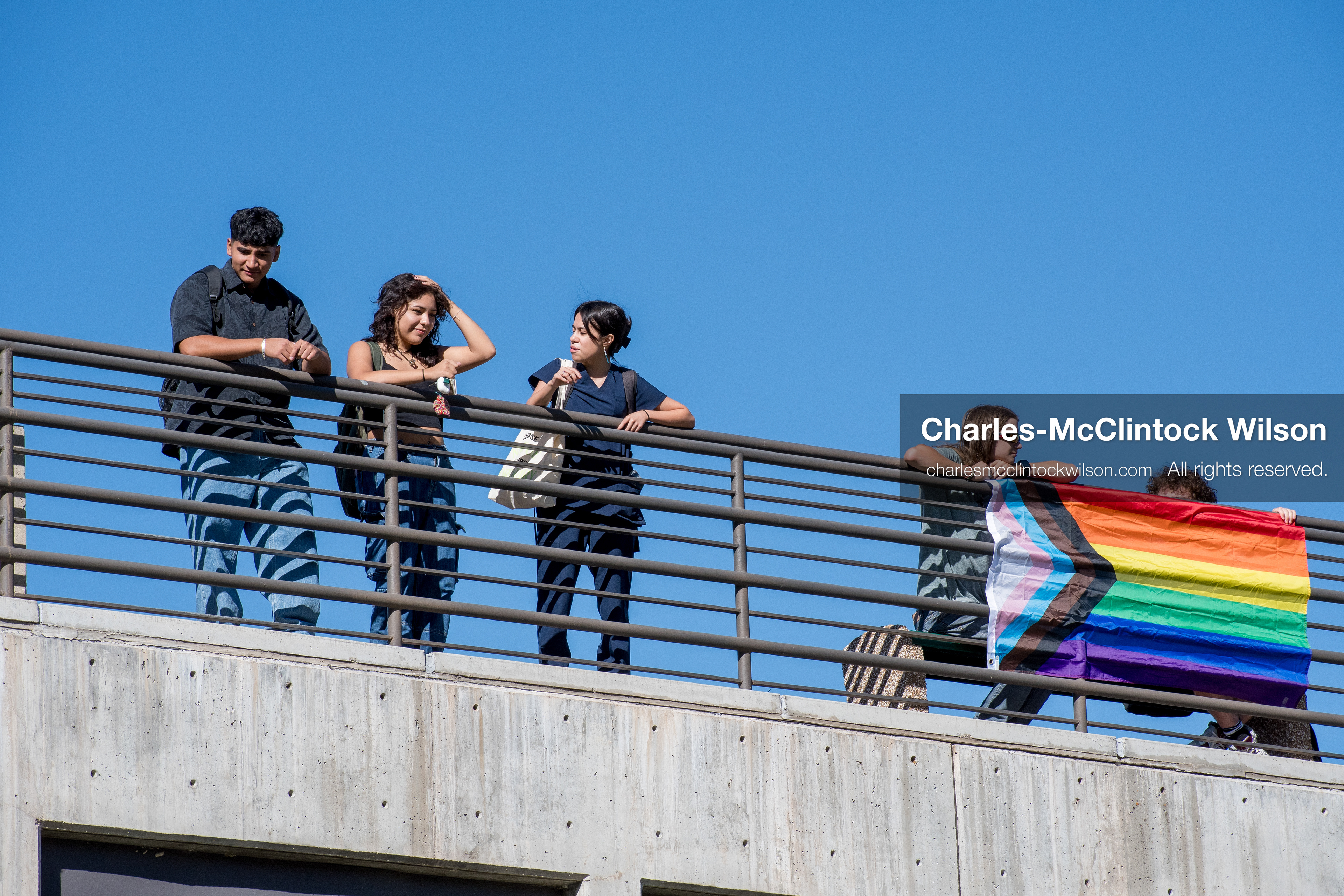 September 10, 2025, Orem, Utah, USA: A group of individuals stand atop the Fountain Courtyard at Utah Valley University, holding a Progress Pride flag during conservative activist Charlie Kirk’s American Comeback Tour appearance. The event drew over 3,000 attendees and was marked by heightened civic tension and symbolic gestures from both supporters and critics. Kirk was fatally shot moments later during the public Q&A session, prompting national scrutiny of campus security protocols and institutional response. (Credit Image: © Charles‑McClintock Wilson/ZUMA Press Wire)