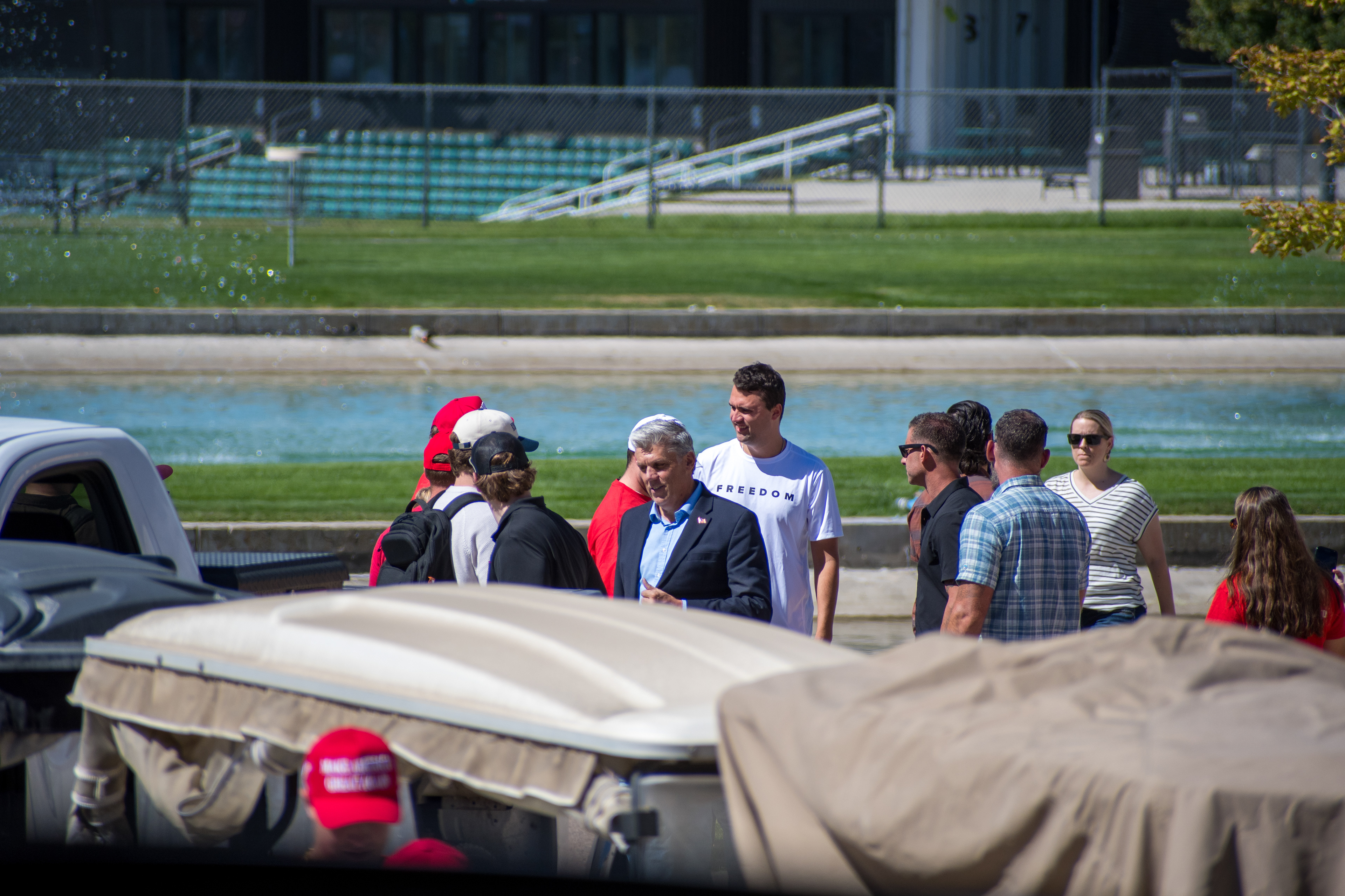 OREM, UTAH – SEPTEMBER 10, 2025: Charlie Kirk arrives at Utah Valley University for a scheduled public event. Walking near a water feature and surrounded by staff and supporters, Kirk enters the venue in a moment of calm anticipation. The image marks the beginning of his final public appearance, reflecting the quiet buildup before the crowd engagement that followed. © Charles-McClintock Wilson / ZUMA Press