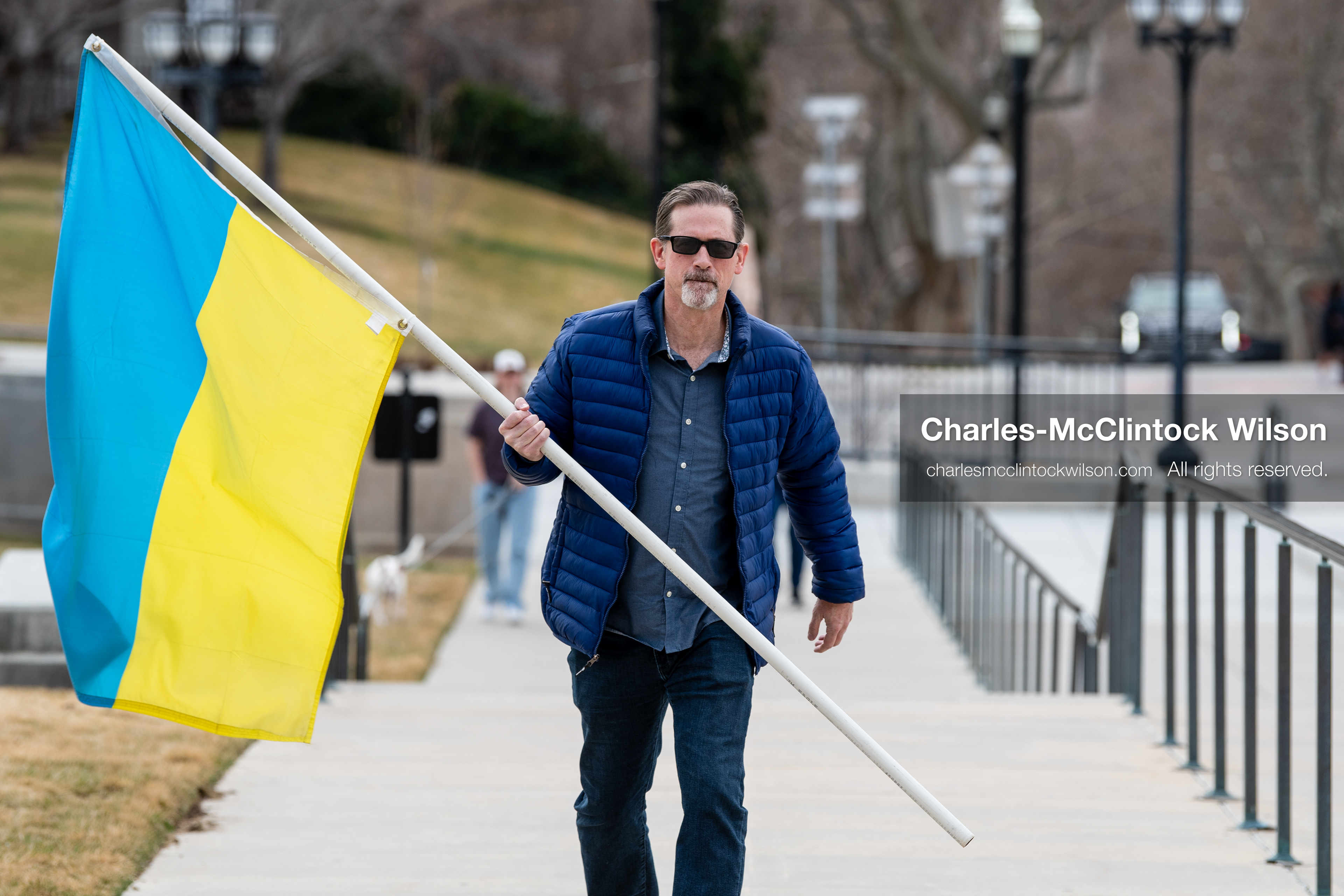 February 28, 2026, Salt Lake City, Utah, USA: JOHN BOYD, a Utah Forward Party candidate for Utah House District 53, carries a large Ukrainian flag while walking near the Utah State Capitol during the Stand With Ukraine rally. The gathering marked the four year anniversary of the full scale Russian invasion of Ukraine and brought community members together in support of Ukrainians and local humanitarian efforts. (Credit Image: © Charles McClintock Wilson/ZUMA Press Wire)