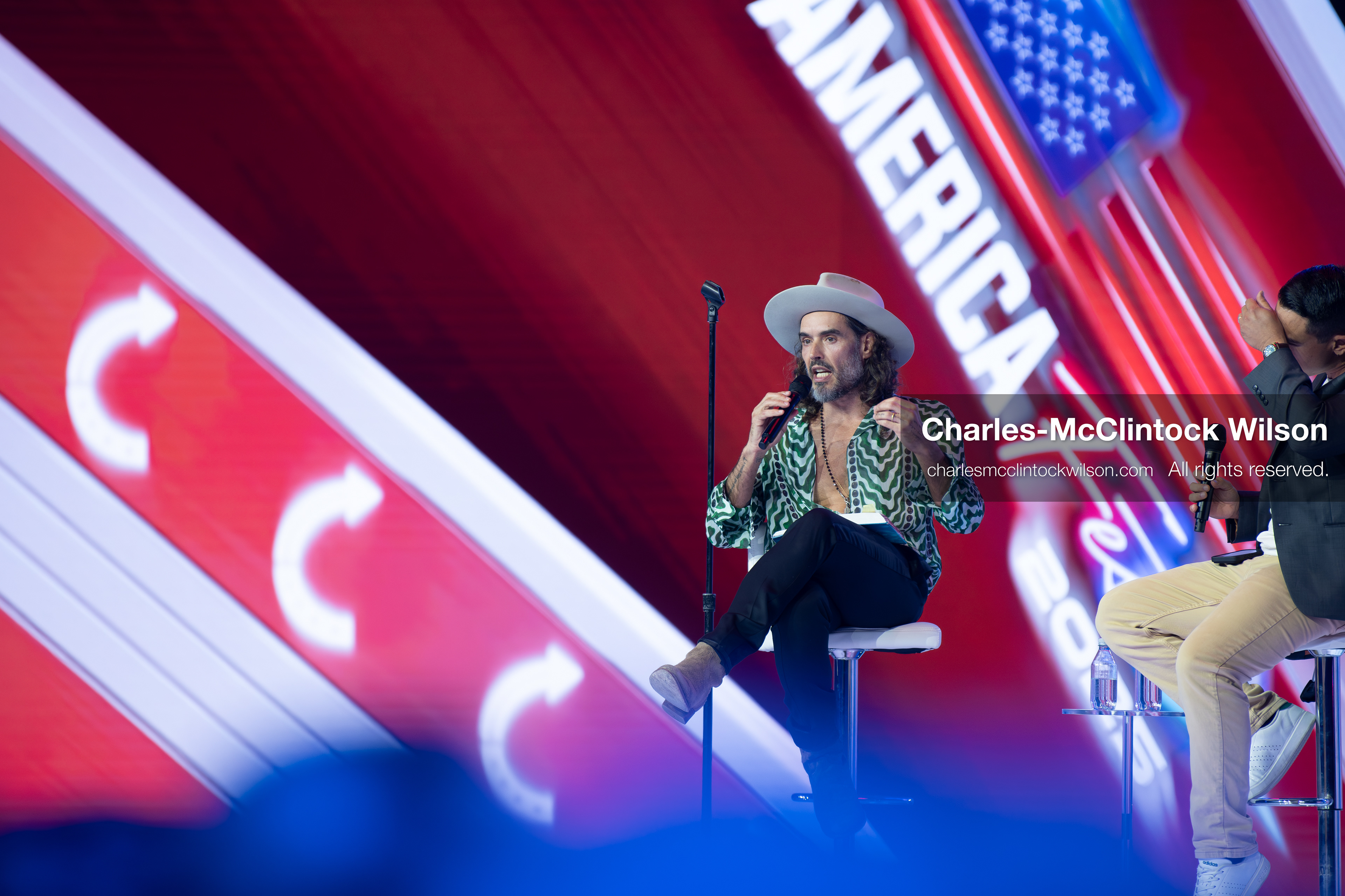 December 18, 2025, Phoenix, Arizona, USA: Russell Brand speaks during Day One of Turning Point USA’s AmericaFest 2025 at the Phoenix Convention Center in Phoenix, Arizona.   (Credit Image: © Charles‑McClintock Wilson/ZUMA Press Wire)
