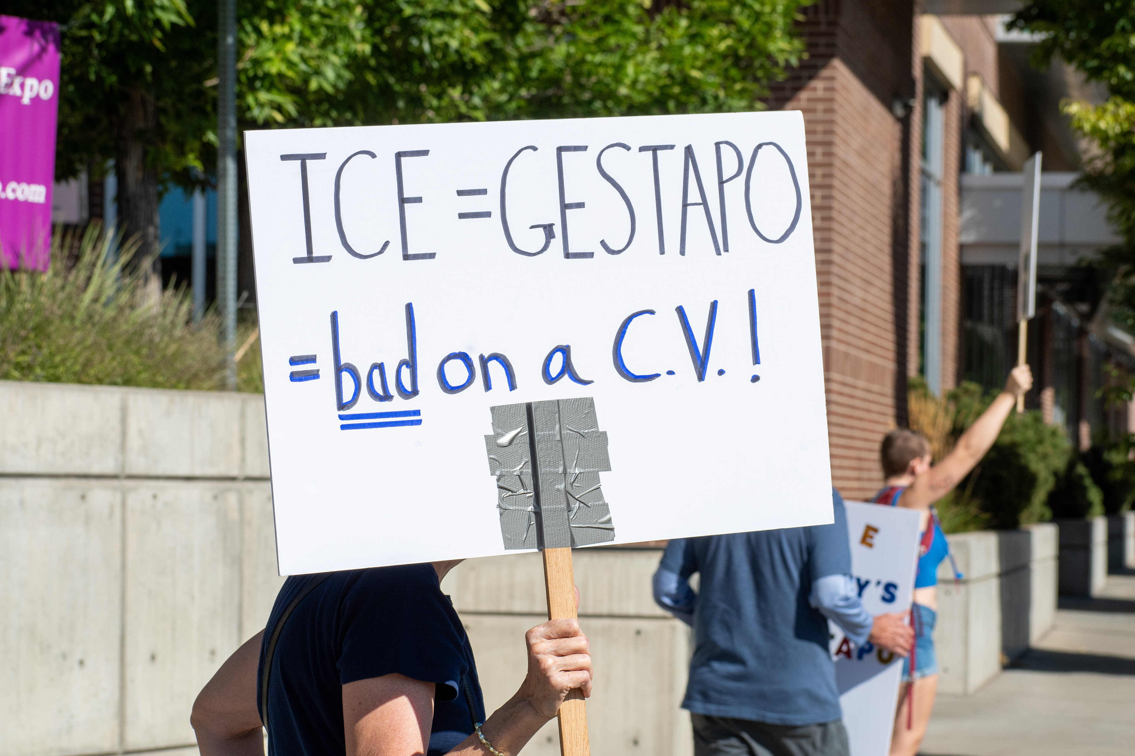September 15, 2025 – Provo, Utah, United States: A protest sign reading “ICE = GESTAPO #Not on a C.V.!!” is held outside the Utah Valley Convention Center during a demonstration against the Department of Homeland Security career expo. The message draws historical parallels and critiques the inclusion of immigration enforcement experience on professional résumés. Photograph by Charles‑McClintock Wilson / ZUMA Press Wire