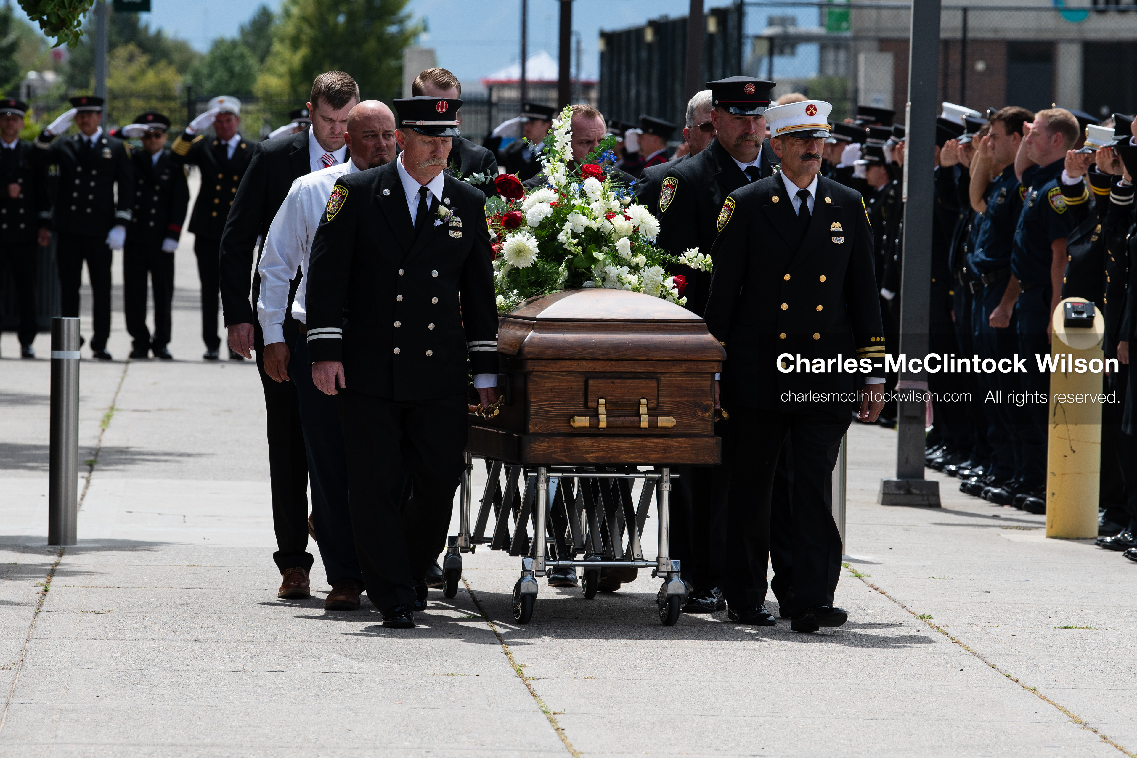 Firefighters and pallbearers escort the casket of Provo Fire Captain Spencer Long outside the UCCU Center on the campus of Utah Valley University in Orem, Utah, on Wednesday, July 29, 2026. More than 300 people came to the public memorial ceremony to honor Captain Long, his wife Katrina, and three of their sons, who died after a flash flood hit their campsite near the Sunglow Campground in Wayne County. (Photo by Charles-McClintock Wilson/Sipa USA)