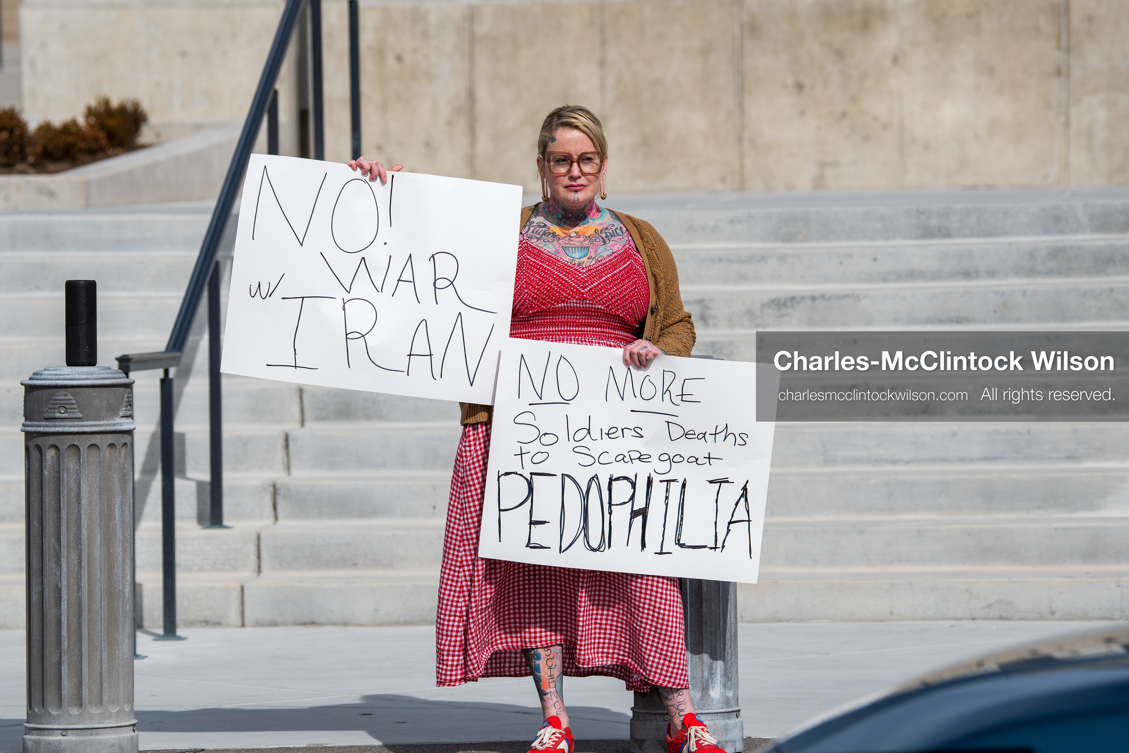 February 28, 2026, Salt Lake City, Utah, USA: A demonstrator stands on the steps of the Utah State Capitol holding two handwritten protest signs during the Stand With Ukraine rally. The gathering marked the four year anniversary of the full scale Russian invasion of Ukraine and brought community members together in support of Ukrainians and local humanitarian efforts. (Credit Image: © Charles McClintock Wilson/ZUMA Press Wire)