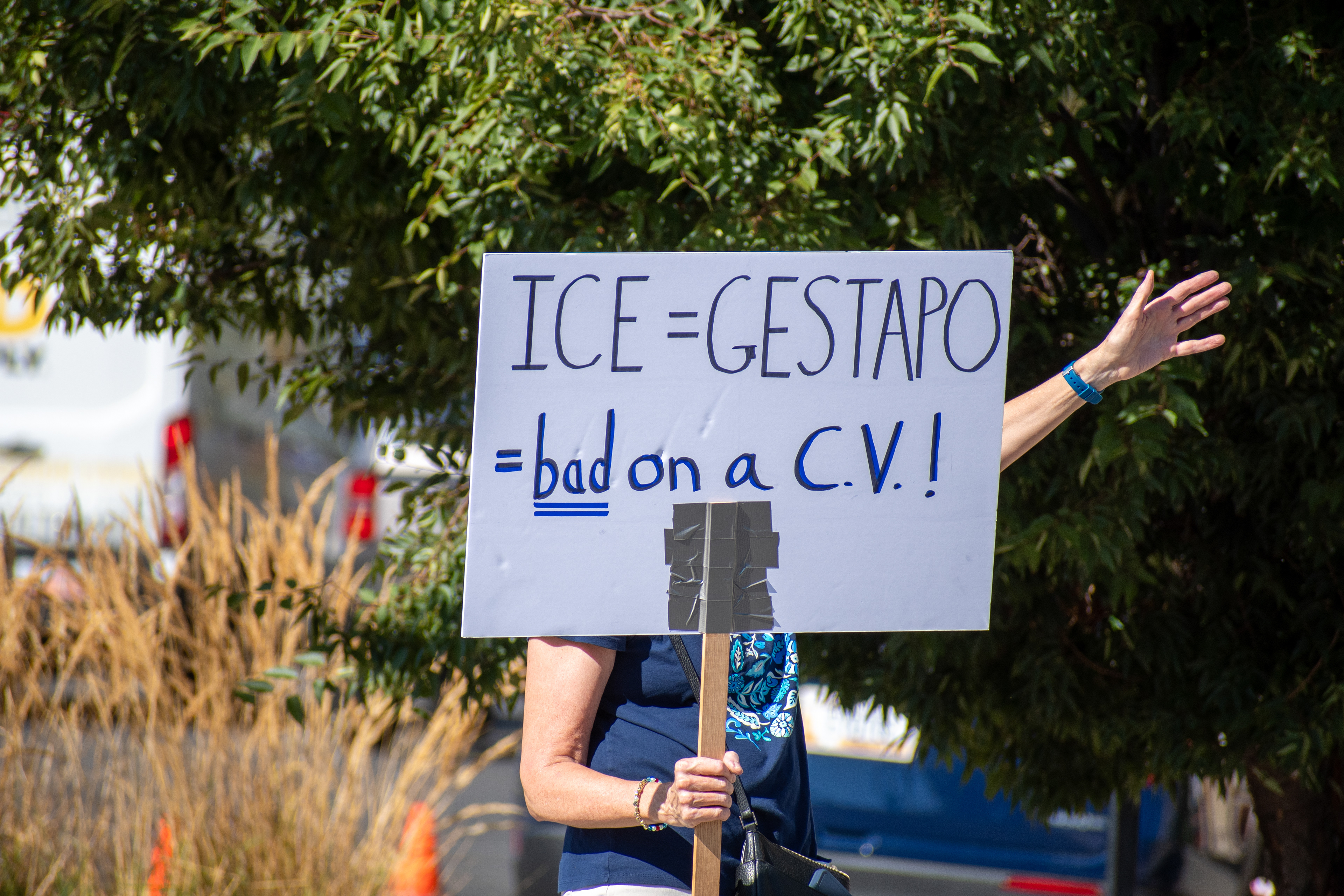 September 15, 2025 – Provo, Utah, United States: A protest sign reading “ICE = GESTAPO #Not on a C.V.!!” is held outside the Utah Valley Convention Center during a demonstration against the Department of Homeland Security career expo. The message draws historical parallels and critiques the inclusion of immigration enforcement experience on professional résumés. Photograph by Charles‑McClintock Wilson / ZUMA Press Wire