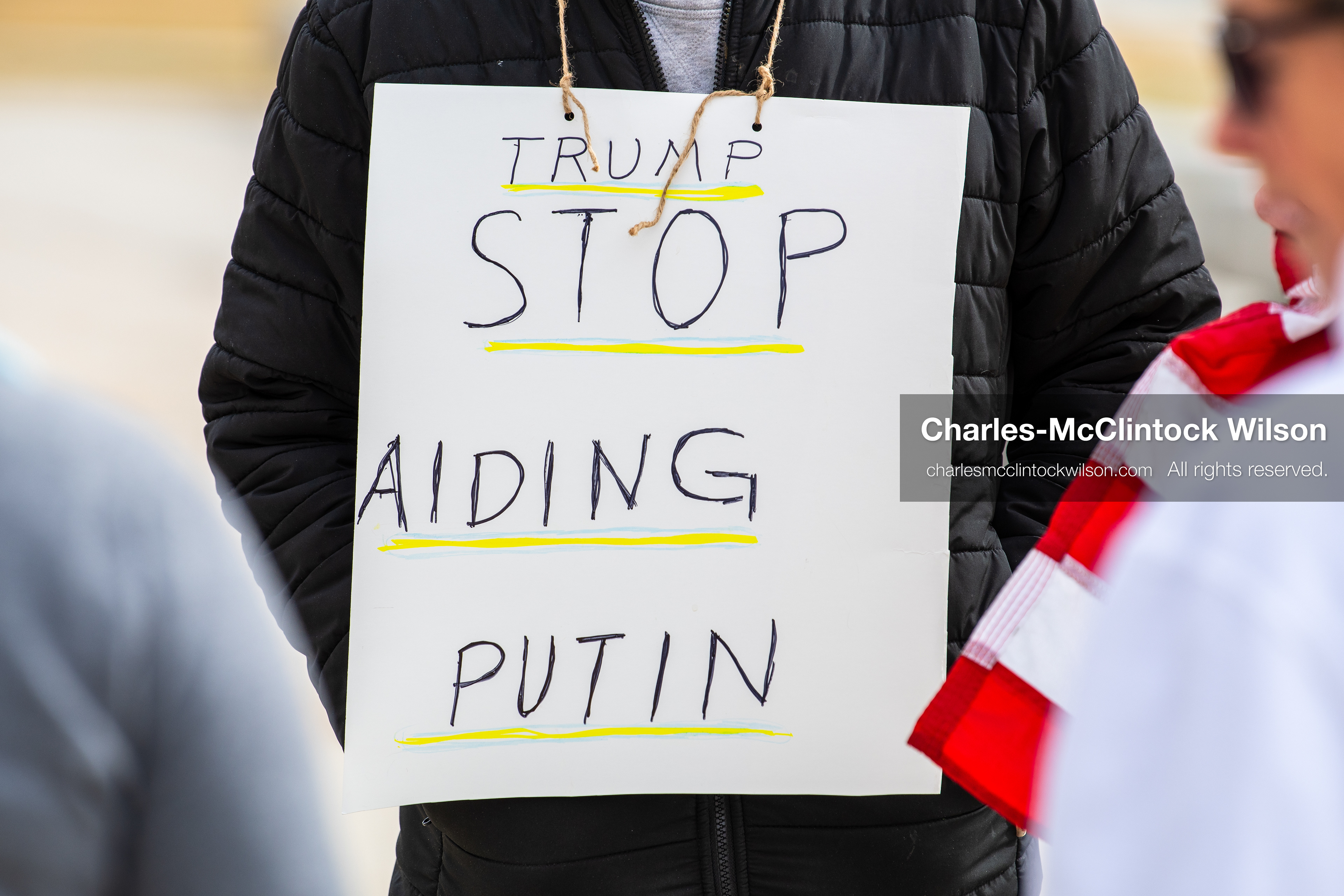 February 28, 2026, Salt Lake City, Utah, USA: A demonstrator wears a sign reading Trump Stop Aiding Putin during the Stand With Ukraine rally at the Utah State Capitol. The gathering marked the four year anniversary of the full scale Russian invasion of Ukraine and brought community members together in support of Ukrainians and local humanitarian efforts. (Credit Image: © Charles McClintock Wilson/ZUMA Press Wire)