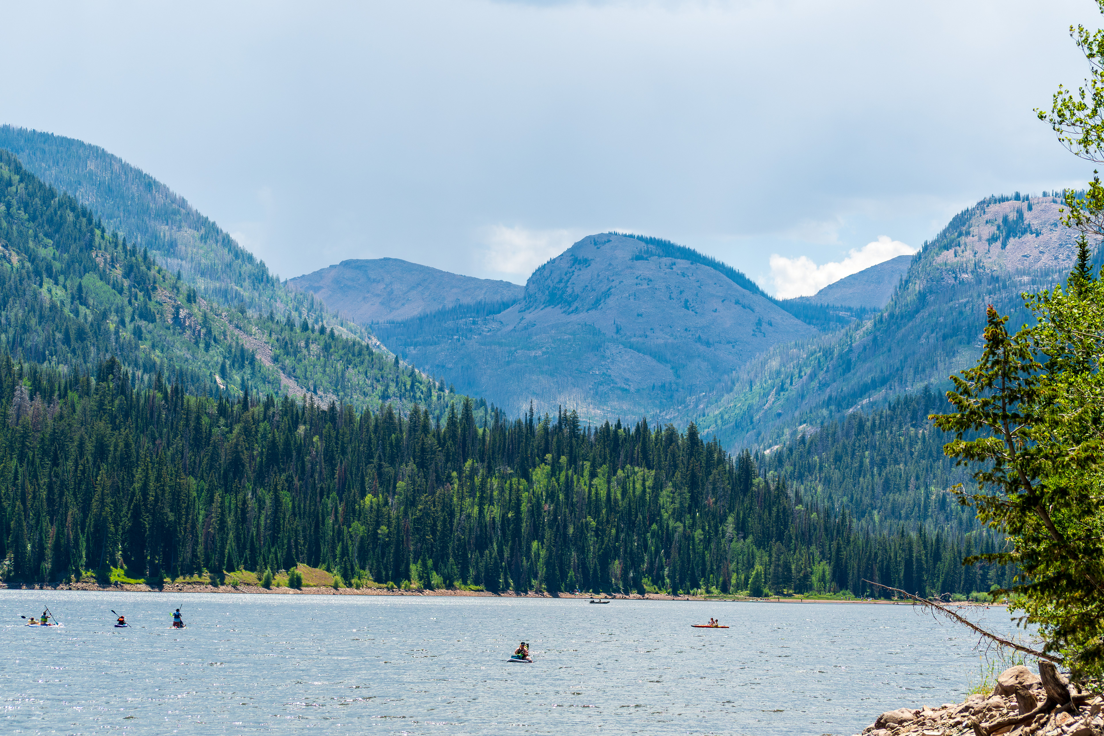 Summit County, Utah – July 20, 2025: People enjoy outdoor recreation on kayaks and paddleboards at Smith and Morehouse Reservoir.