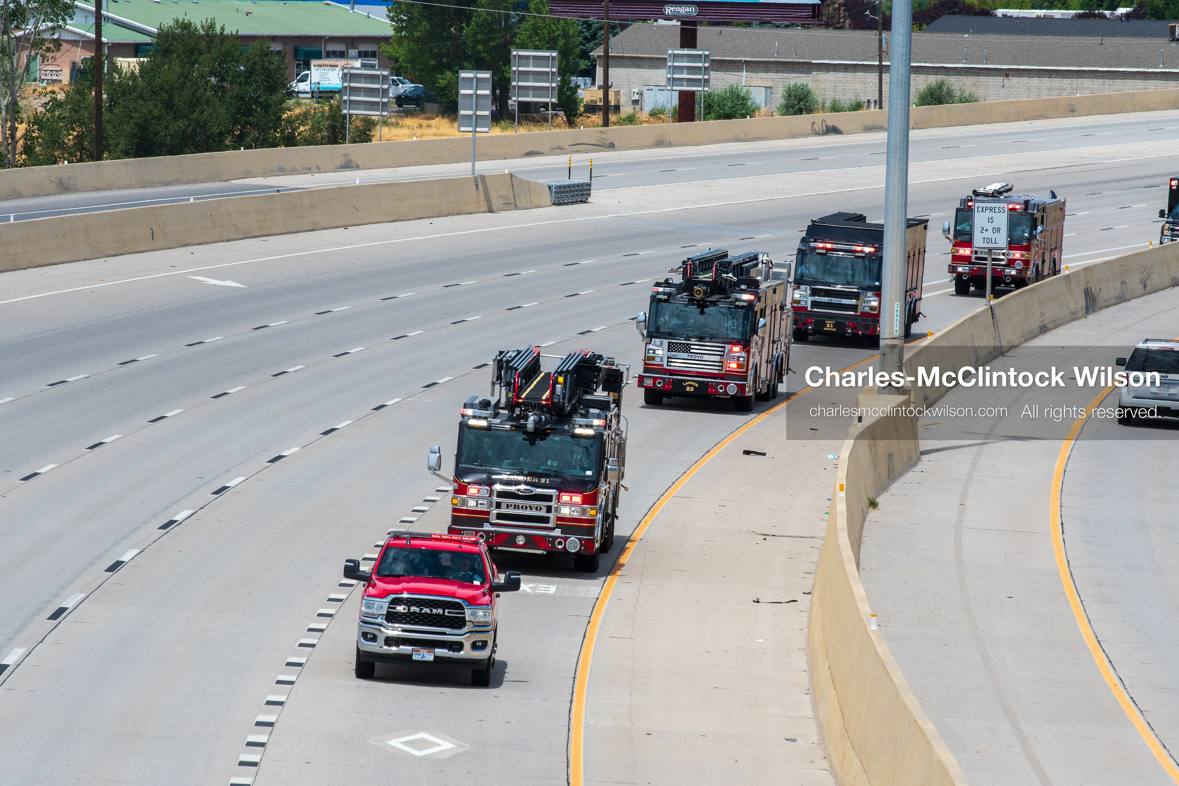 A long line of fire engines and emergency response vehicles travels in a single file column along the express lane of Interstate 15 during a funeral procession for Provo Fire Captain Spencer Long and his family in Orem, Utah, on Wednesday, July 29, 2026. More than 300 people came to the public memorial ceremony to honor the five family members who died after a flash flood hit their campsite near the Sunglow Campground in Wayne County. (Photo by Charles-McClintock Wilson/Sipa USA)