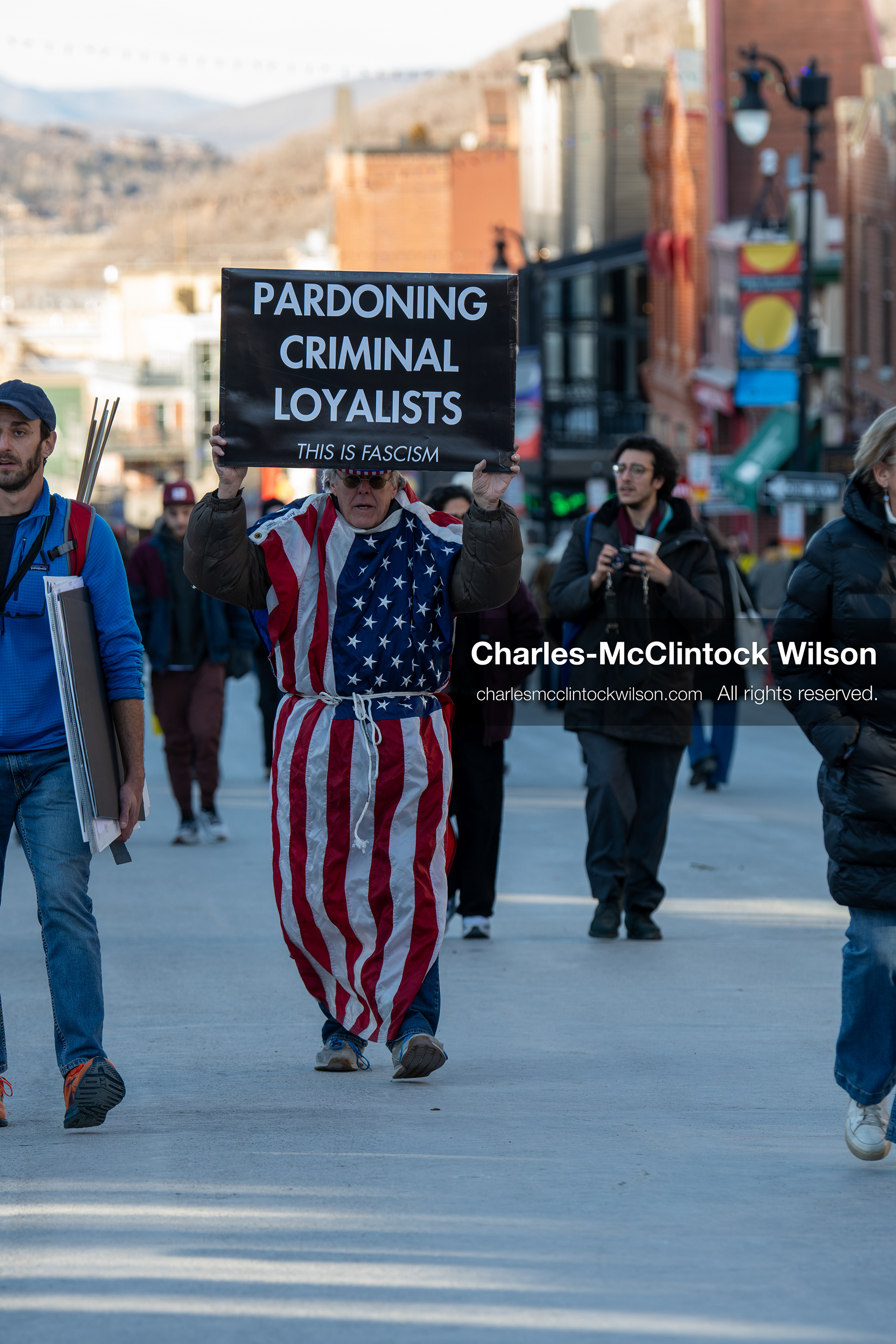 January 26, 2026, Park City, Utah, USA: A demonstrator dressed in an American flag-themed outfit walks down Main Street holding a sign during a protest opposing U.S. Immigration and Customs Enforcement (I.C.E.) ICE agents at the Sundance Film Festival in Park City, Utah, on Monday, Jan. 26, 2026. The event was held in response to the fatal shooting of Alex Pretti by a U.S. Border Patrol officer in Minneapolis. (Credit Image: © Charles McClintock Wilson/ZUMA Press Wire)