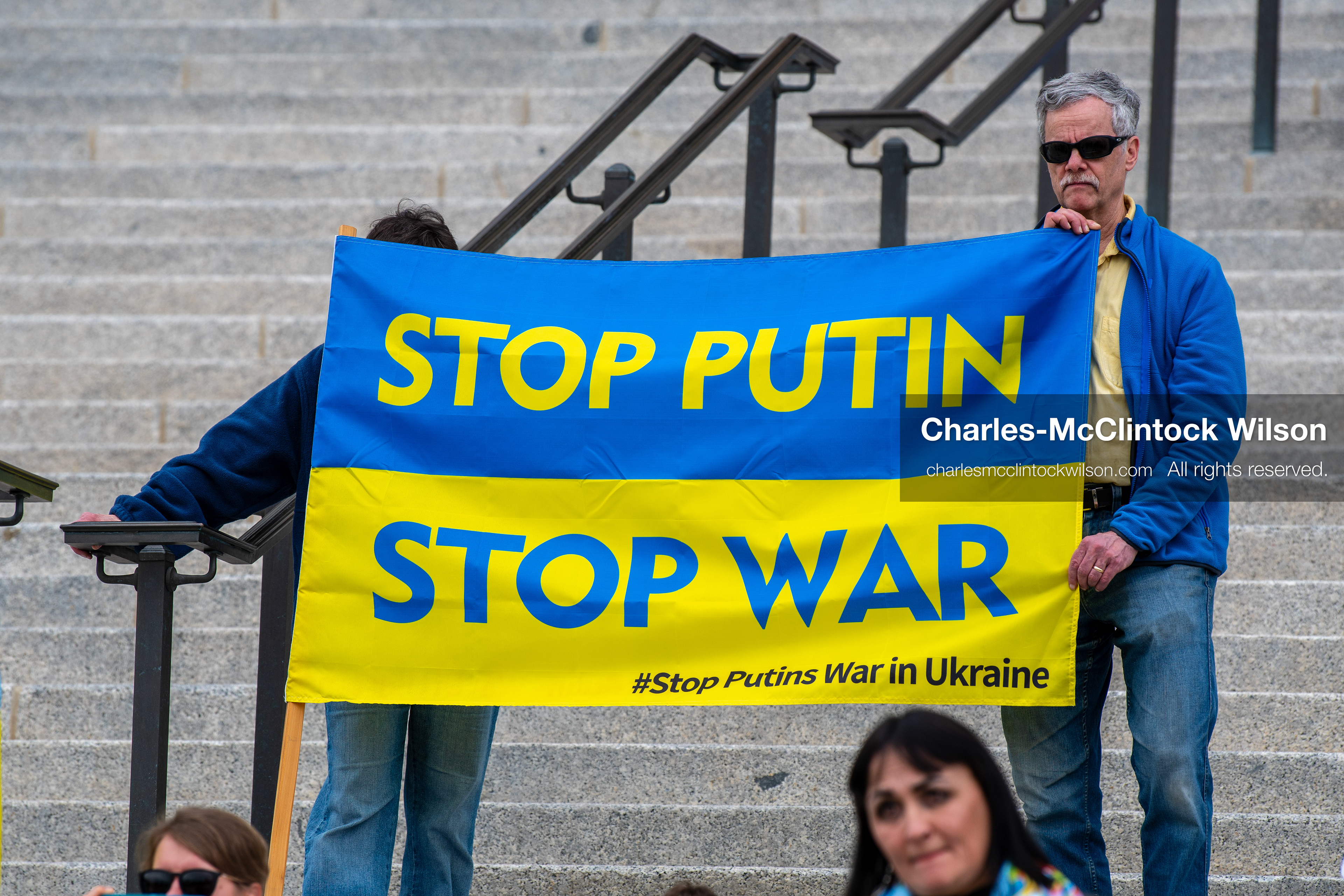  February 28, 2026, Salt Lake City, Utah, USA: Demonstrators hold a large blue and yellow banner resembling the Ukrainian flag with the words Stop Putin Stop War during the Stand With Ukraine rally at the Utah State Capitol. The gathering marked the four year anniversary of the full scale Russian invasion of Ukraine and brought community members together in support of Ukrainians and local humanitarian efforts. (Credit Image: © Charles McClintock Wilson/ZUMA Press Wire)