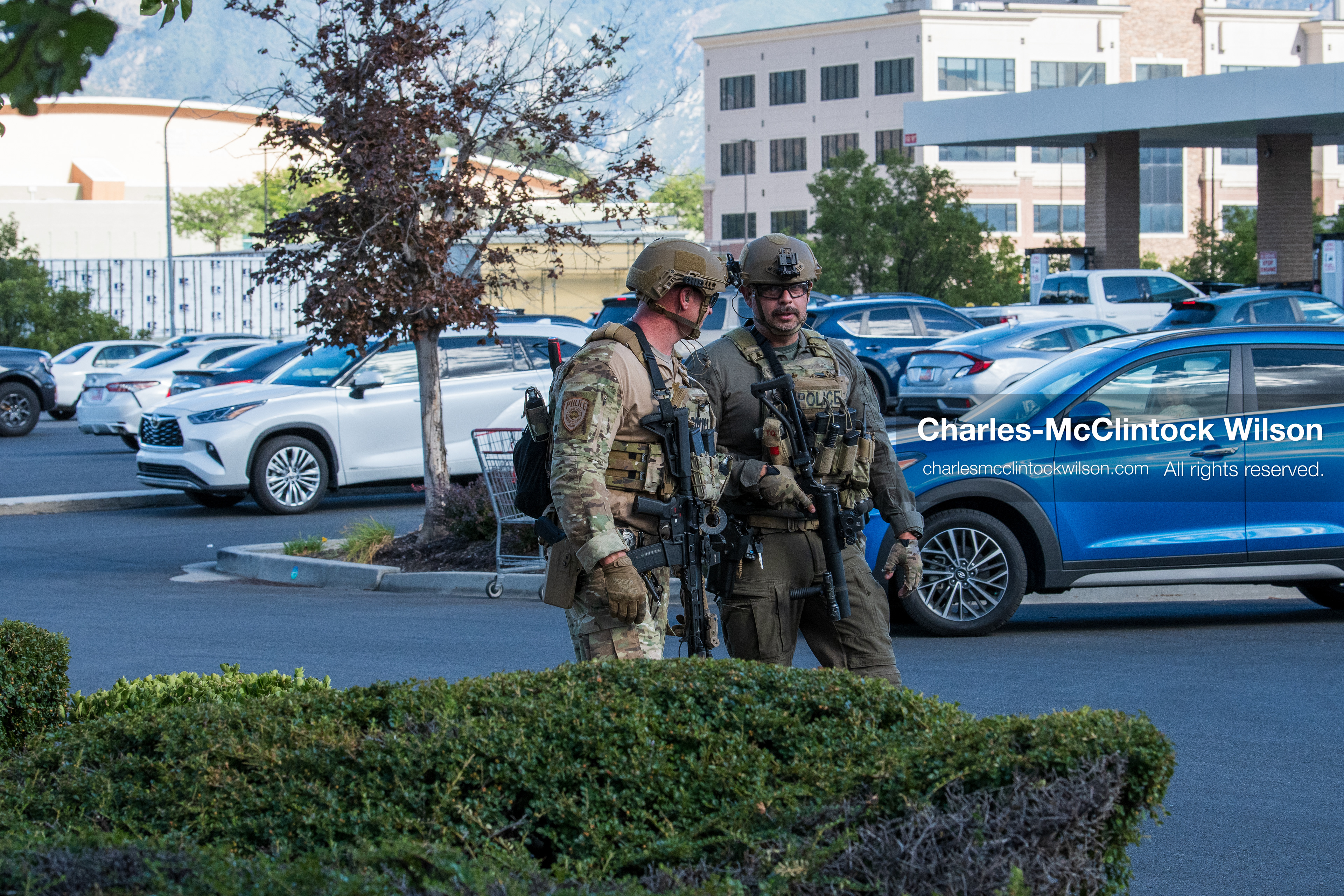 August 17, 2026, Murray, Utah, USA: Two armed law enforcement officers in tactical gear patrol the parking lot outside Intermountain Medical Center on Monday. Multiple police agencies secured the hospital perimeter as a safety precaution after shooting victims were brought in from a fatal shootout outside a funeral in nearby Kearns. (Credit Image: © Charles McClintock Wilson/ZUMA Press Wire)