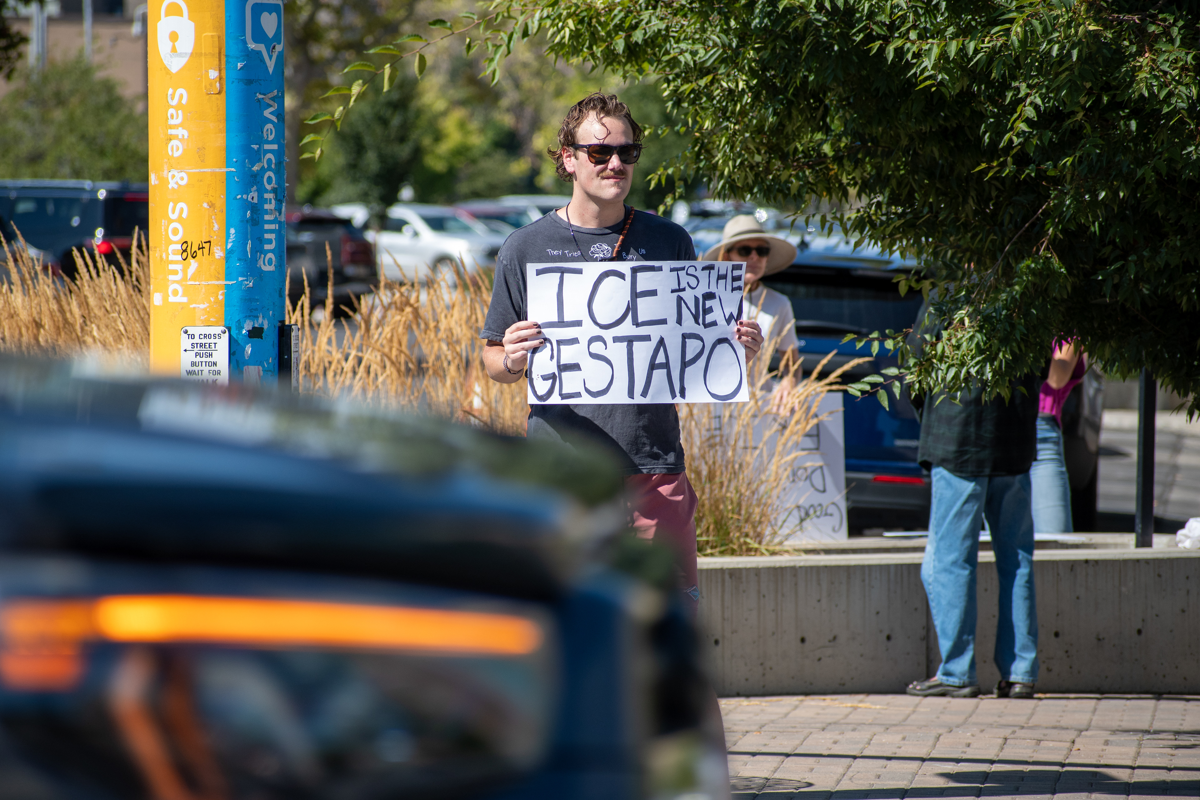 September 15, 2025 – Provo, Utah, United States: A demonstrator holds a sign reading “ICE IS THE NEW GESTAPO” outside the Utah Valley Convention Center during a protest against the Department of Homeland Security career expo. The message draws historical parallels and critiques immigration enforcement practices. Photograph by Charles‑McClintock Wilson / ZUMA Press Wire