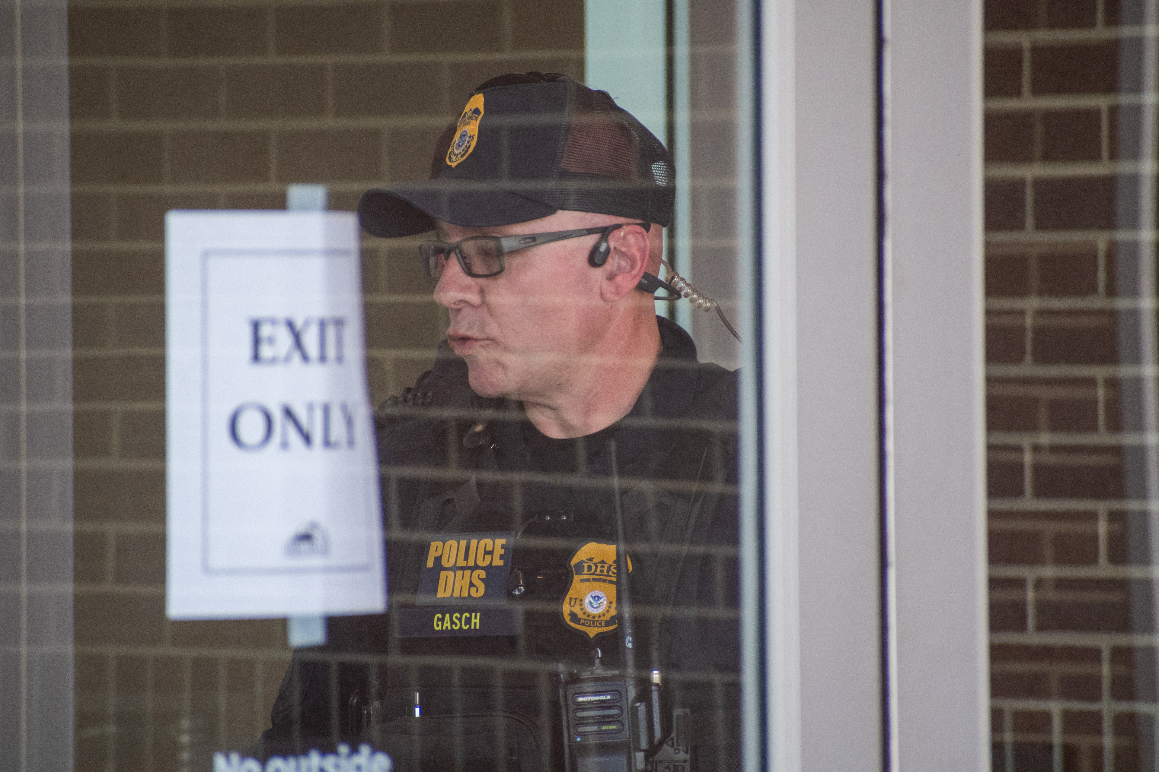 September 15, 2025 – Provo, Utah, United States: A Homeland Security police officer stands behind a glass door marked “EXIT ONLY” at the Utah Valley Convention Center during a Department of Homeland Security career expo focused on recruiting law enforcement and security personnel. Photograph by Charles‑McClintock Wilson / ZUMA Press Wire