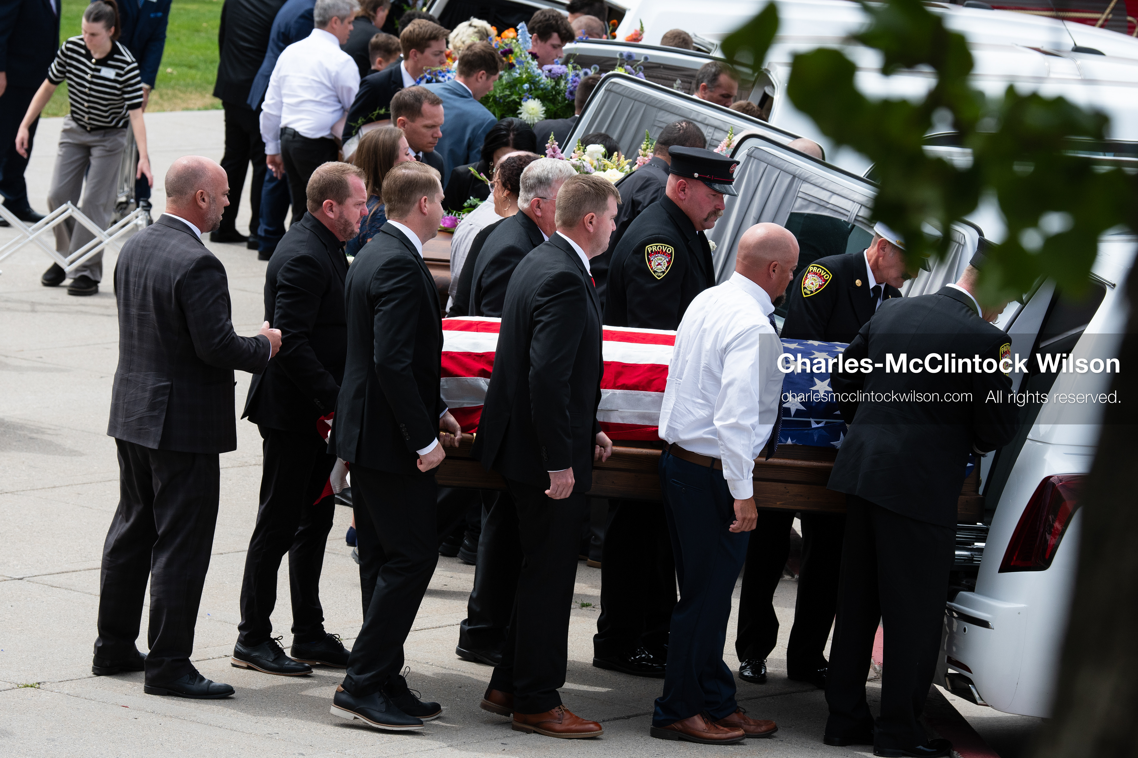 Firefighters and pallbearers load the flag-draped casket of Provo Fire Captain Spencer Long into a white hearse outside the UCCU Center at Utah Valley University in Orem, Utah, on Wednesday, July 29, 2026. More than 300 people came to the public memorial ceremony to honor Captain Long, his wife Katrina, and three of their sons, who died after a flash flood hit their campsite near the Sunglow Campground in Wayne County. (Photo by Charles-McClintock Wilson/Sipa USA)