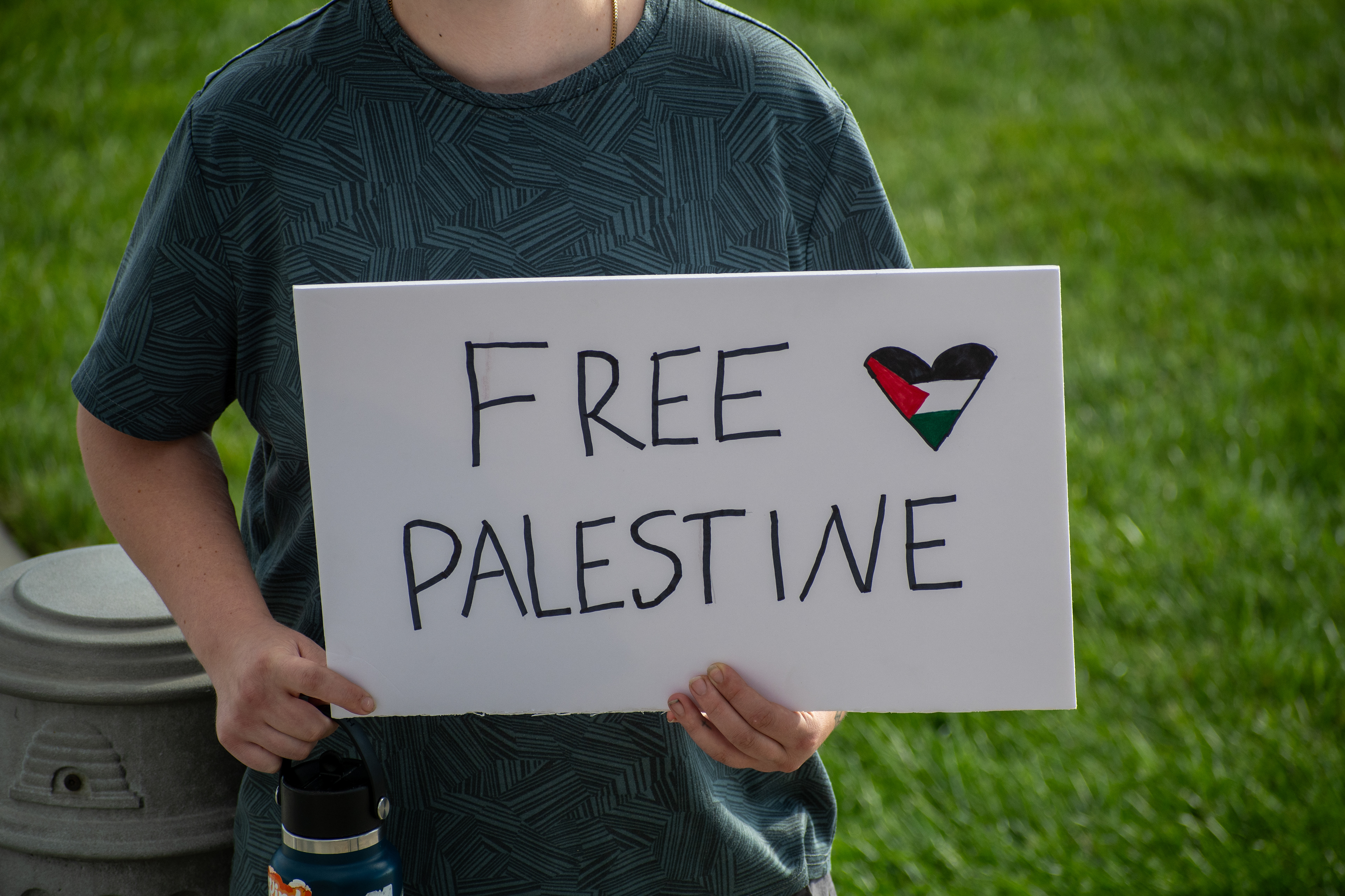 October 10, 2025, Salt Lake City, Utah, USA: A demonstrator stands on a grassy area during the Free Palestine Rally organized in front of the Utah State Capitol. The participant holds a sign featuring symbolic colors and imagery associated with Palestinian solidarity. (Credit Image: © Charles-McClintock Wilson/ZUMA Press Wire)