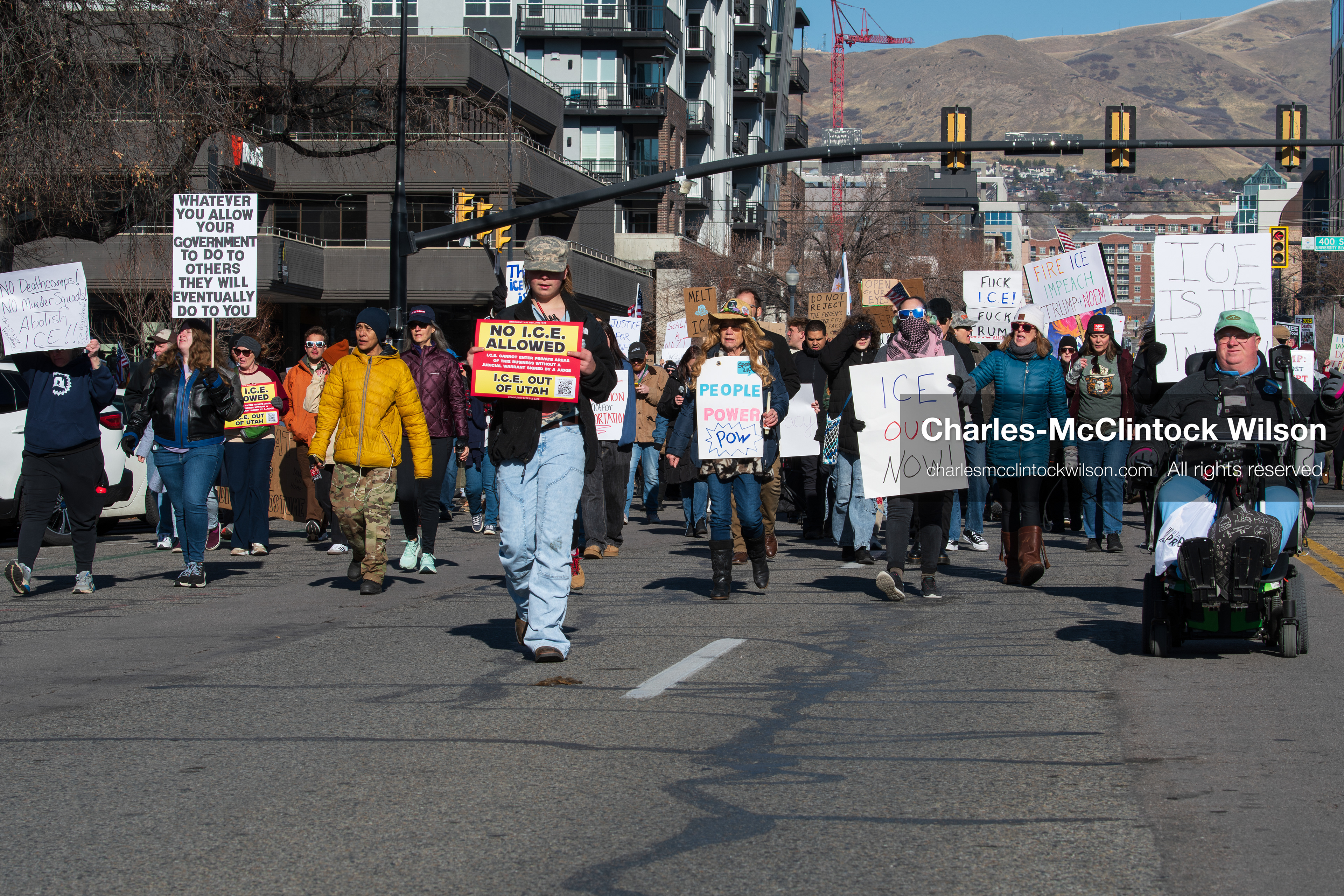 Salt Lake City, Utah, January 10, 2026: A group of demonstrators marches through downtown Salt Lake City during the ICE Out for Good protest, which began at Washington Square Park, with participants carrying signs and personal items as they walk together. (Credit Image: © Charles‑McClintock Wilson/ZUMA Press Wire)