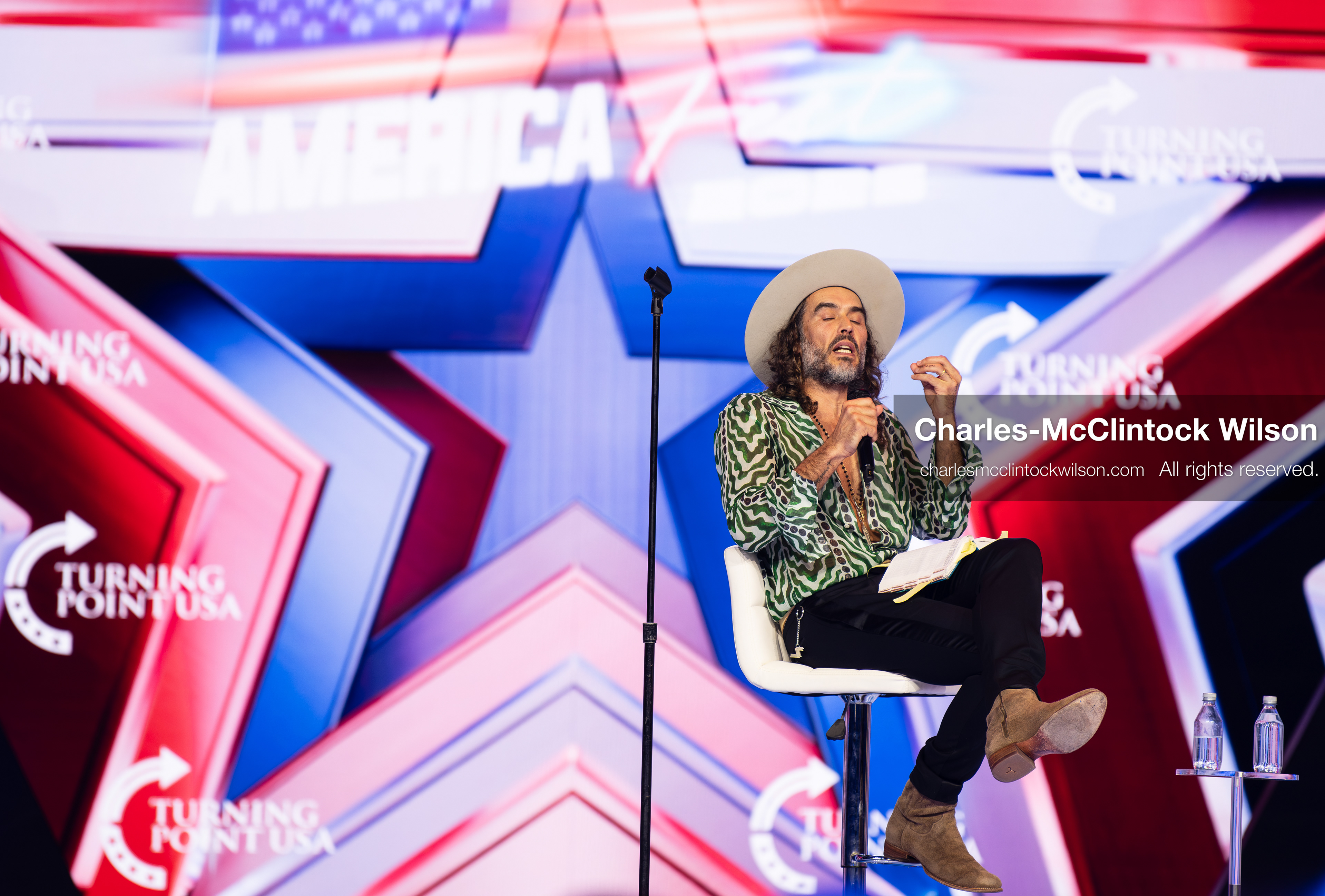 December 18, 2025, Phoenix, Arizona, USA: Russell Brand speaks during Day One of Turning Point USA’s AmericaFest 2025 at the Phoenix Convention Center in Phoenix, Arizona.   (Credit Image: © Charles‑McClintock Wilson/ZUMA Press Wire)