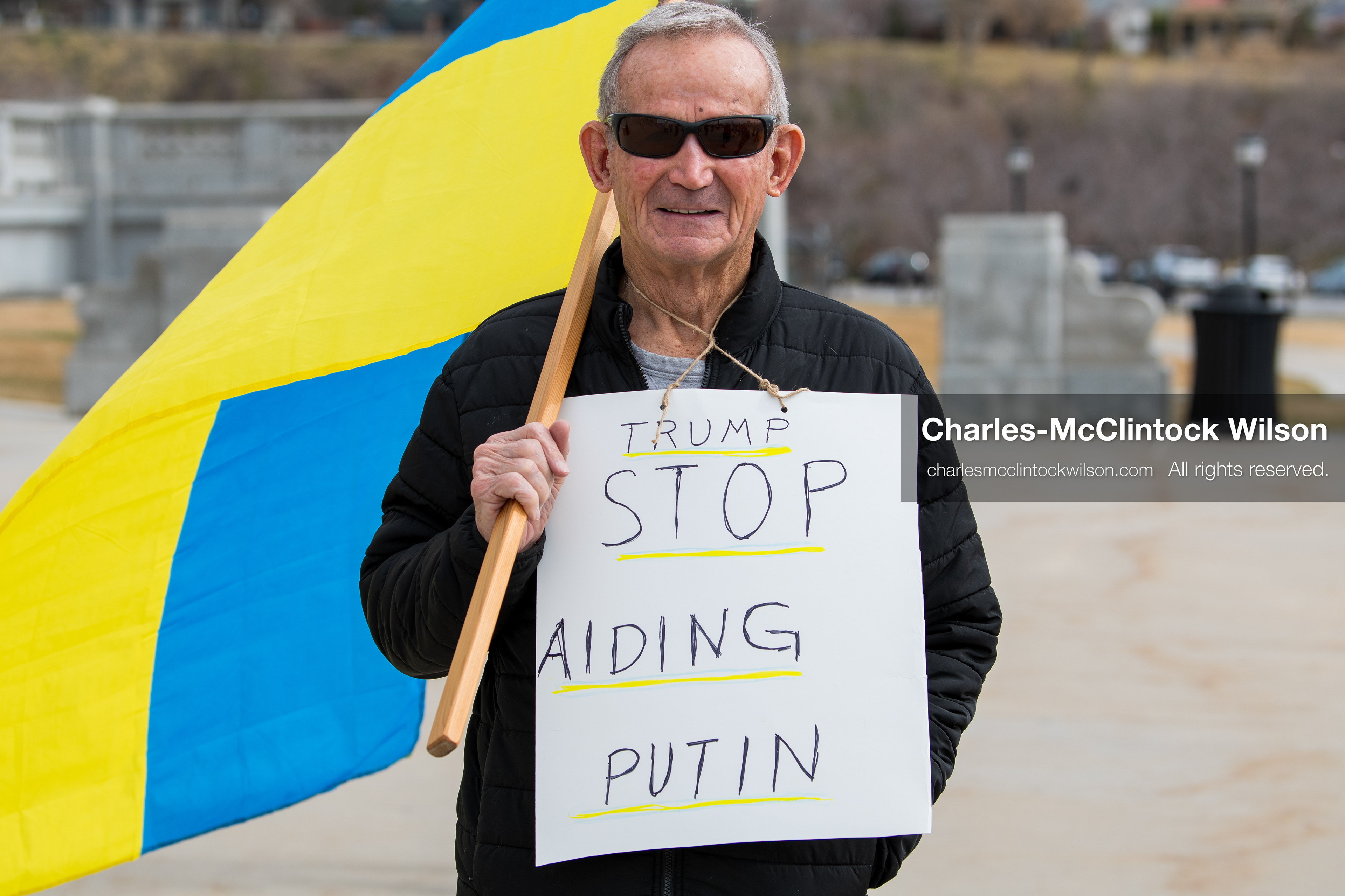 February 28, 2026, Salt Lake City, Utah, USA: A demonstrator wears a sign reading Trump Stop Aiding Putin during the Stand With Ukraine rally at the Utah State Capitol. The gathering marked the four year anniversary of the full scale Russian invasion of Ukraine and brought community members together in support of Ukrainians and local humanitarian efforts. (Credit Image: © Charles McClintock Wilson/ZUMA Press Wire)