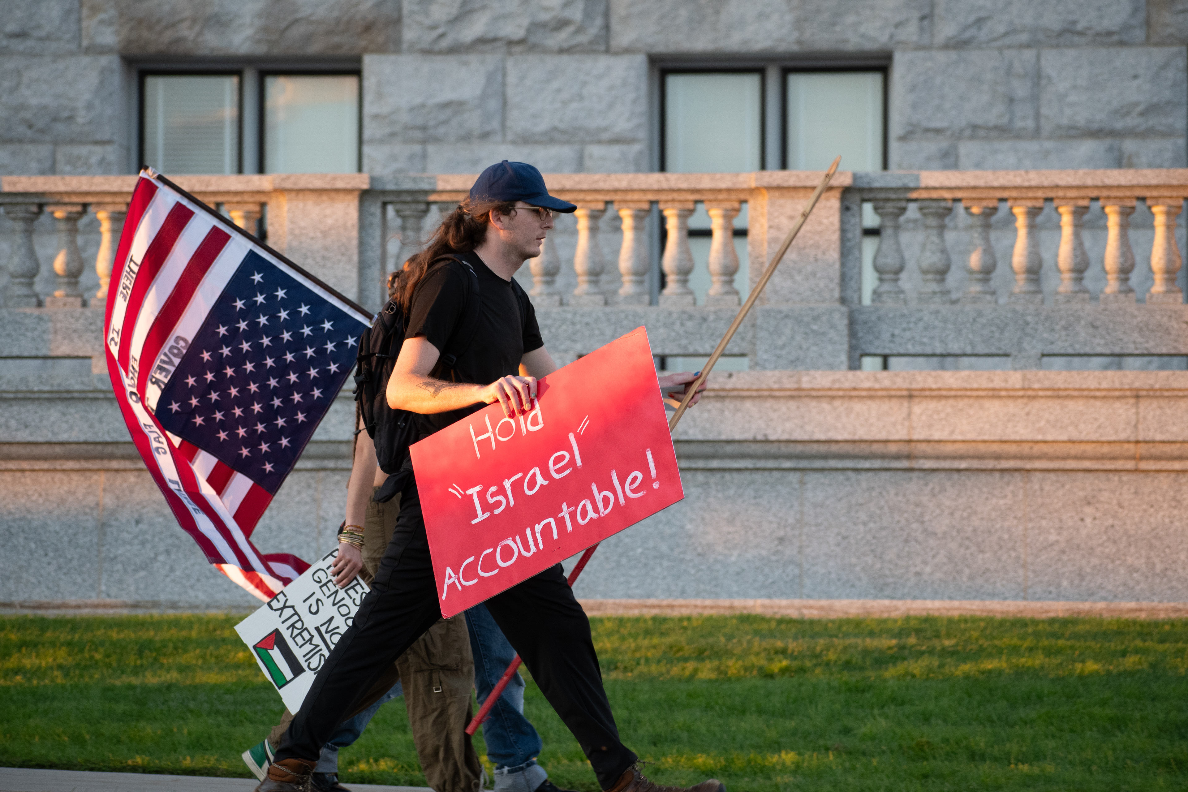 October 10, 2025, Salt Lake City, Utah, USA: Pro-Palestine demonstrators walk along the sidewalk in front of the Utah State Capitol during the Free Palestine Rally. Participants carry flags and signs while assembling near the building's stone balustrades. (Credit Image: © Charles-McClintock Wilson/ZUMA Press Wire)