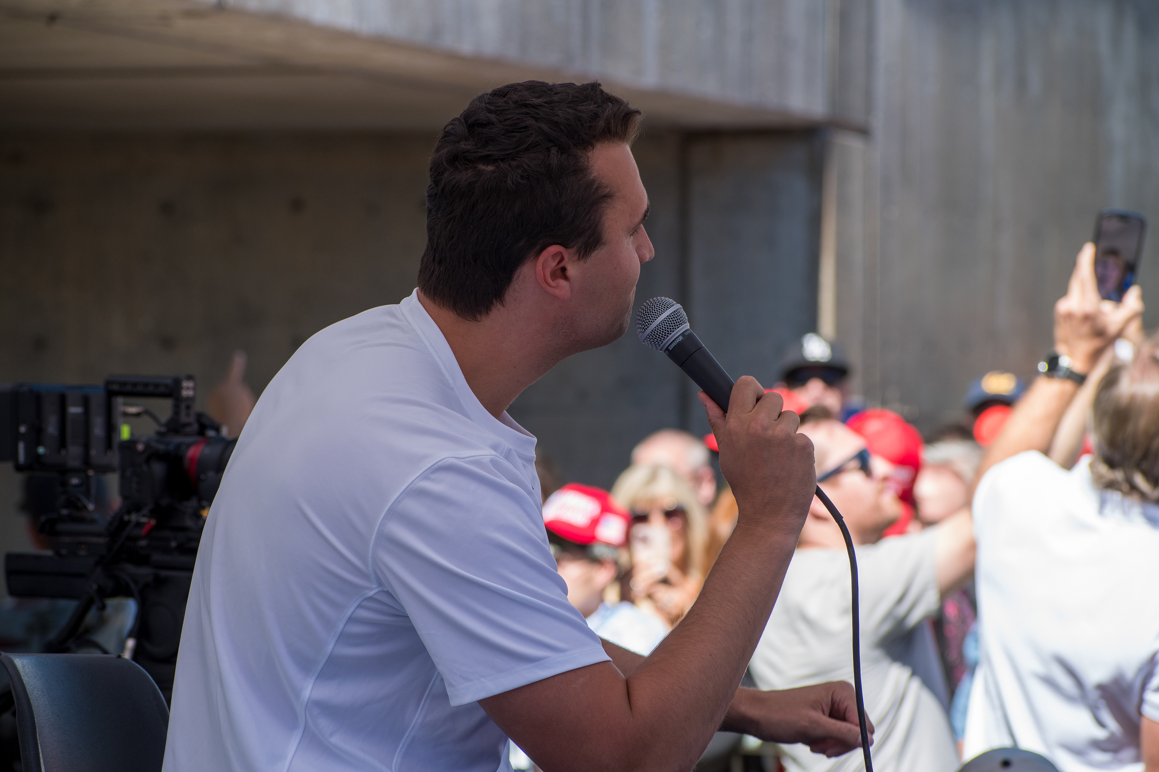 OREM, UTAH – SEPTEMBER 10, 2025: Charlie Kirk addresses supporters during a public event at Utah Valley University. Speaking into a handheld microphone, Kirk stands before a crowd of attendees—some recording the moment, others cheering in red hats—as media crews document the scene. The image reflects Kirk’s direct engagement and the energized atmosphere that defined his final public appearance. © Charles-McClintock Wilson / ZUMA Press