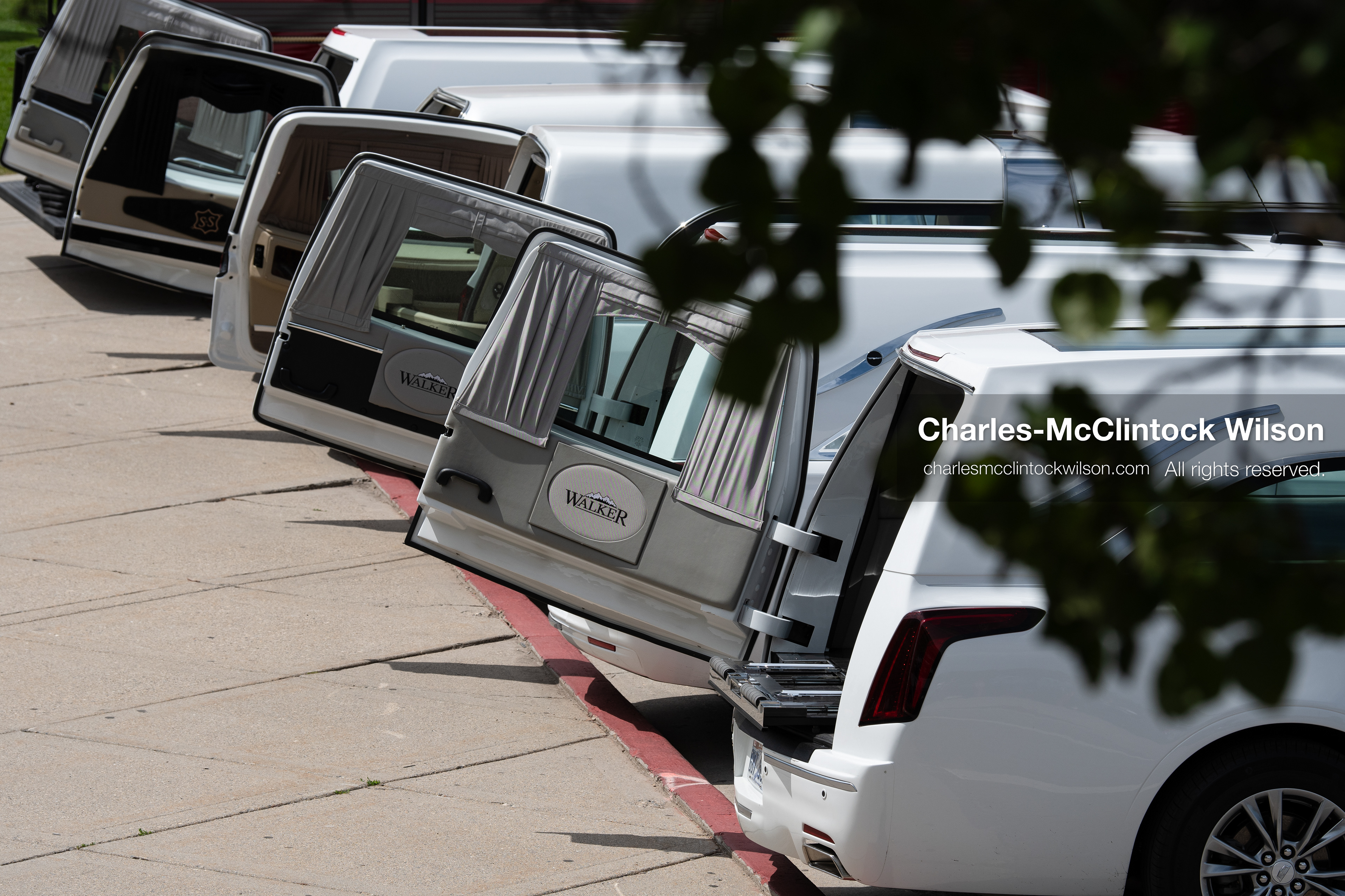A row of white Cadillac hearses sits with back doors open outside the UCCU Center at Utah Valley University in Orem, Utah, on Wednesday, July 29, 2026. More than 300 people came to the public memorial ceremony to honor Provo Fire Captain Spencer Long, his wife Katrina, and three of their sons, who died after a flash flood hit their campsite near the Sunglow Campground in Wayne County. (Photo by Charles-McClintock Wilson/Sipa USA)