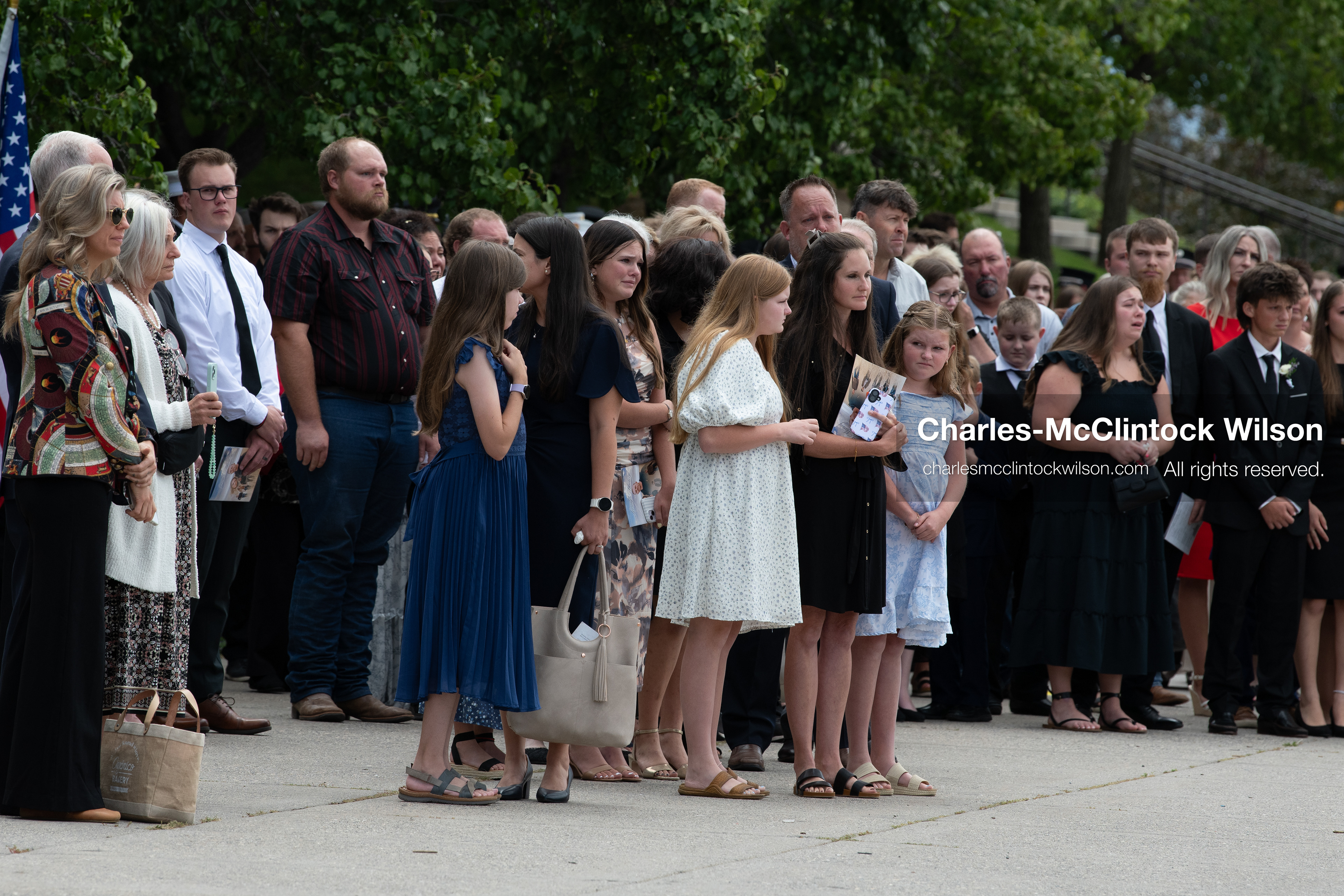 Mourners stand in a crowd outside the UCCU Center at Utah Valley University in Orem, Utah, on Wednesday, July 29, 2026. More than 300 people came to the public memorial ceremony to honor Provo Fire Captain Spencer Long, his wife Katrina, and three of their sons, who died after a flash flood hit their campsite near the Sunglow Campground in Wayne County. (Photo by Charles-McClintock Wilson/Sipa USA)