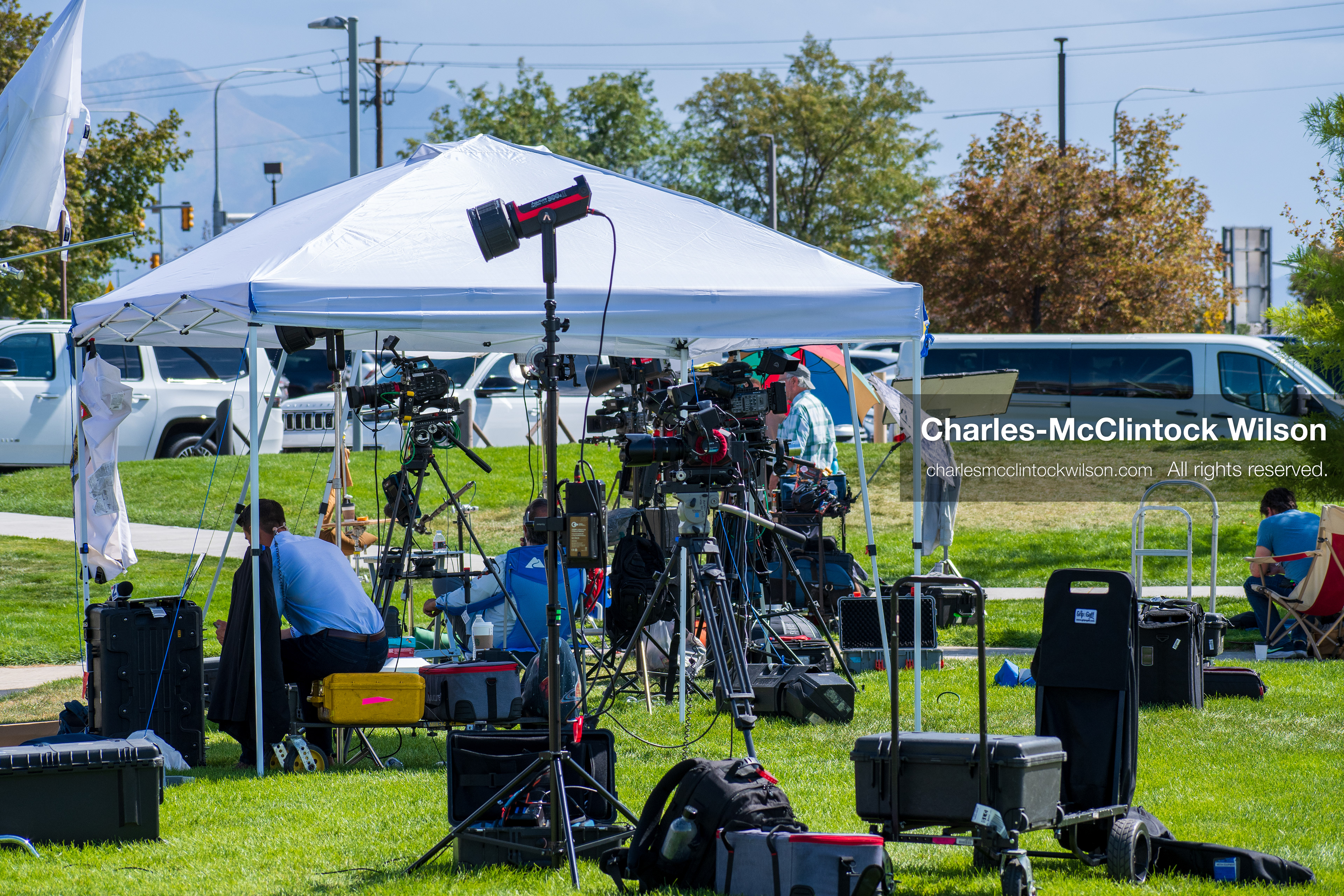 September 12, 2025, Orem, Utah, USA: Members of the press operate cameras and audio equipment beneath a canopy near the site of the fatal shooting of conservative activist Charlie Kirk at Utah Valley University. The media setup includes tripods, boom microphones, and LED lights as crews prepare for live coverage following the September 10 incident.   (Credit Image: © Charles‑McClintock Wilson/ZUMA Press Wire)