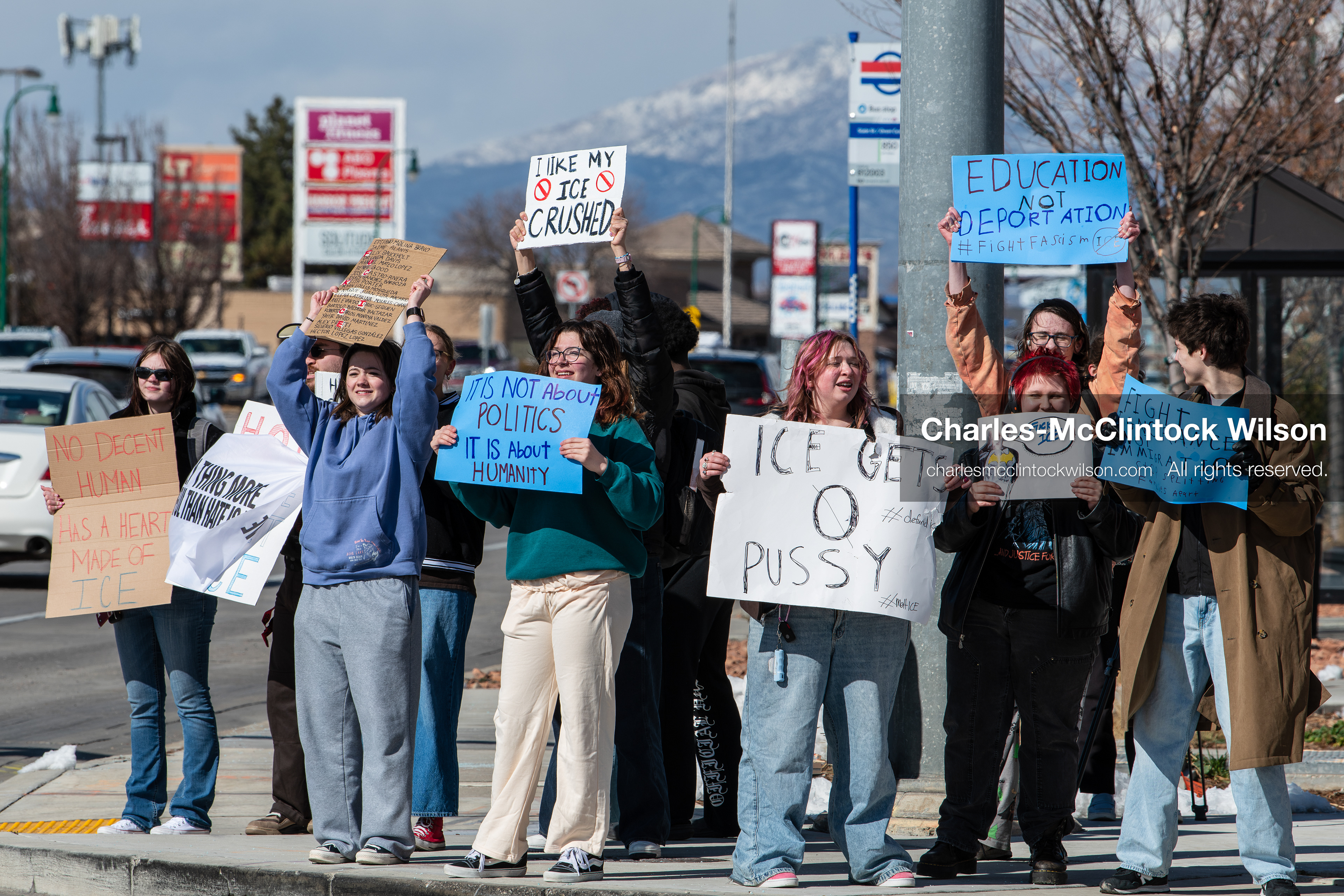 February 20, 2026, Orem, Utah, USA: High school students gather along State Street in front of Orem City Hall during a student led protest against ICE and federal immigration enforcement. Demonstrators hold signs as they stand near the roadway while traffic continues through the area. (Credit Image: © Charles McClintock Wilson/ZUMA Press Wire)