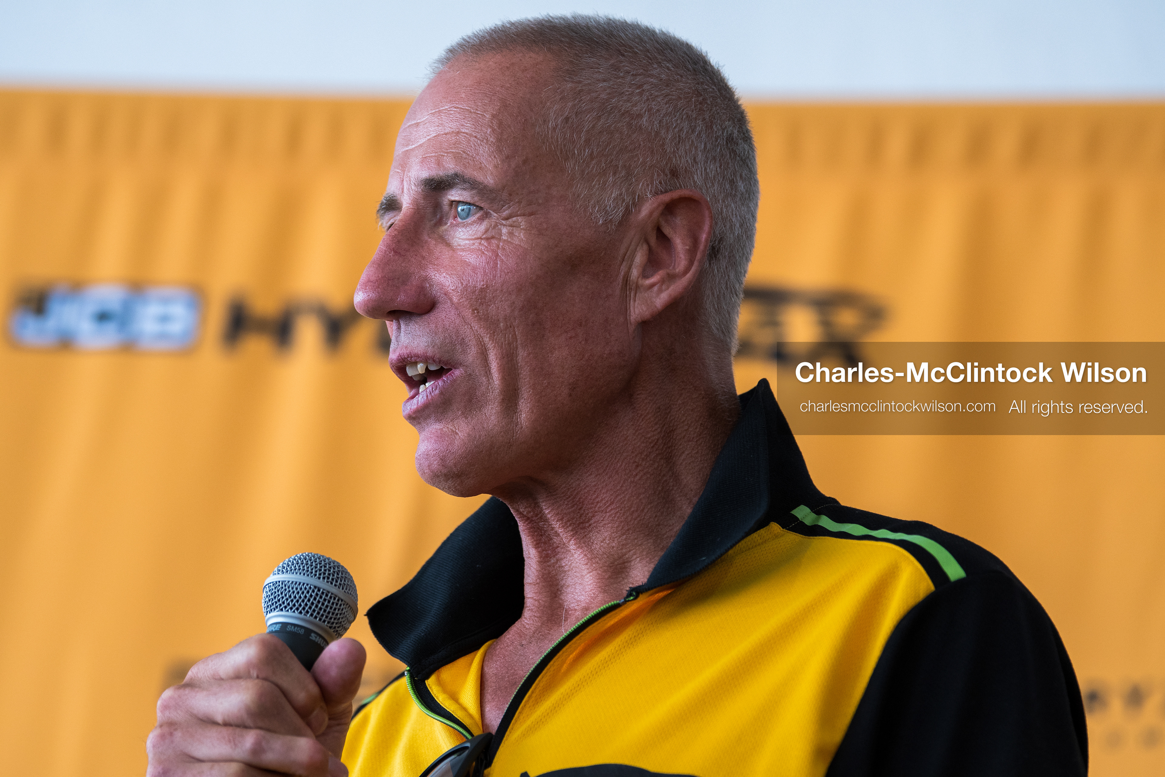 British pilot Andy Green speaks into a microphone during a press conference on the Bonneville Salt Flats on Tuesday. Green steered the hydrogen-powered "JCB Hydromax" streamliner to a historic record-breaking top speed of 406.320 mph during official speed trials. (Photo by Charles-McClintock Wilson/Sipa USA)