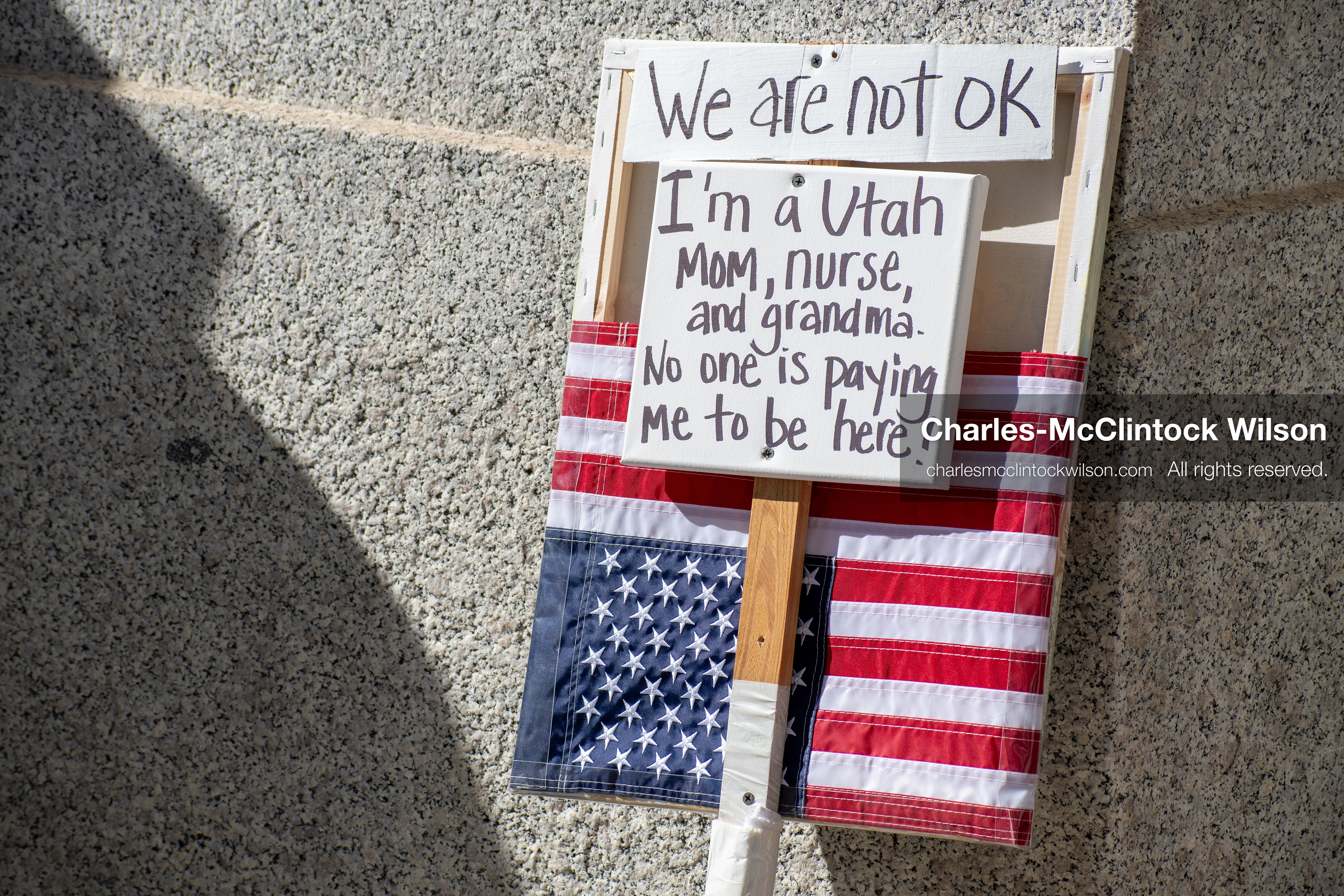 October 18, 2025, Salt Lake City, Utah, USA: A protest sign is displayed against a stone wall during a "No Kings" protest at the Utah State Capitol. The protest was part of a nationwide mobilization.