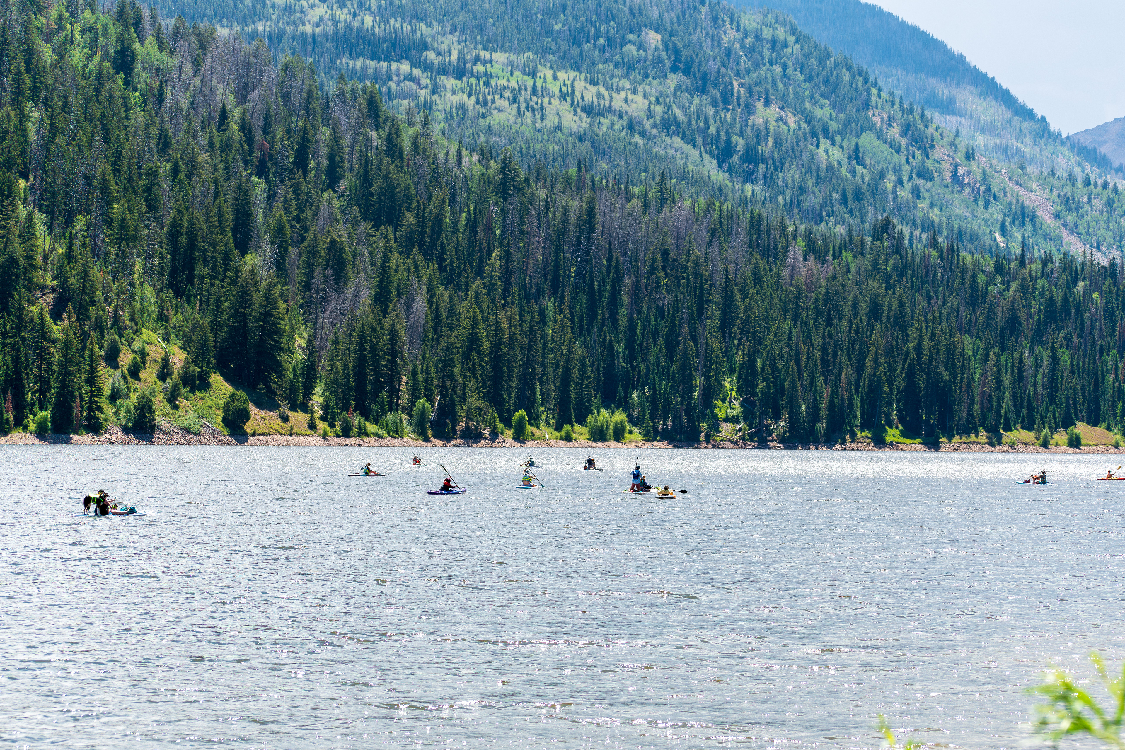 Summit County, Utah – July 20, 2025: People enjoy outdoor recreation on kayaks and paddleboards at Smith and Morehouse Reservoir.