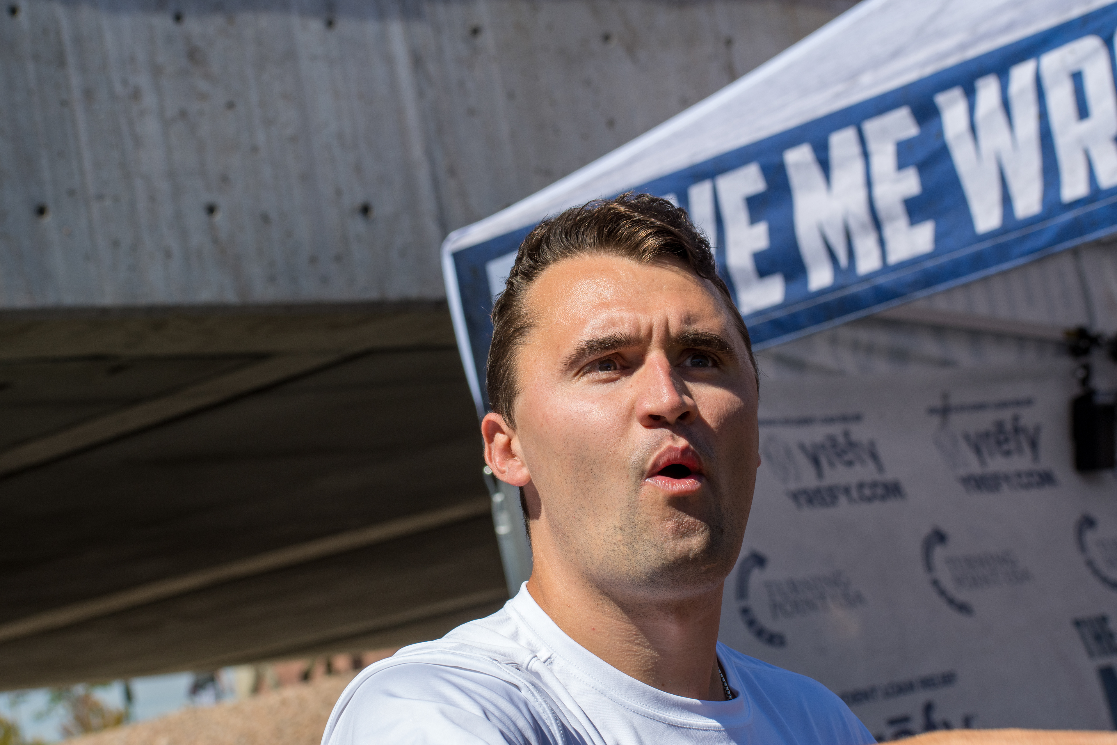 OREM, UTAH – SEPTEMBER 10, 2025: Charlie Kirk speaks with attendees during a public event at Utah Valley University. Positioned near a promotional booth and surrounded by supporters, Kirk appears engaged and expressive in one of his final public moments. The image reflects the atmosphere of direct outreach and energized dialogue that defined the gathering. © Charles-McClintock Wilson / ZUMA Press