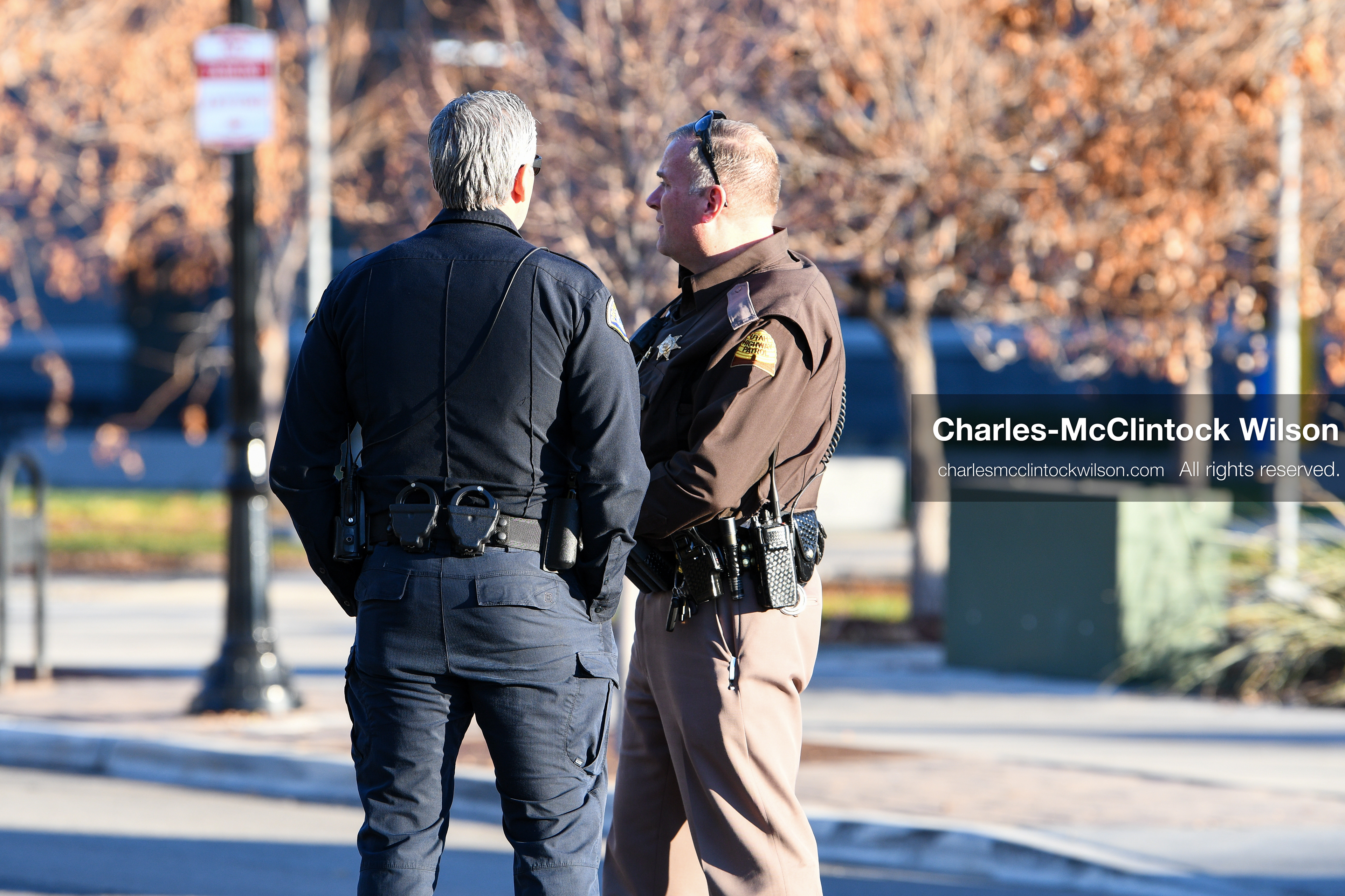 PROVO, UTAH, USA – DECEMBER 11, 2025: A Provo Police officer and a Utah Highway Patrol trooper stand outside the Fourth District Court in Provo during the first in‑person court appearance of Tyler Robinson in the Charlie Kirk murder case. (Credit Image: © Charles‑McClintock Wilson/ZUMA Press Wire)