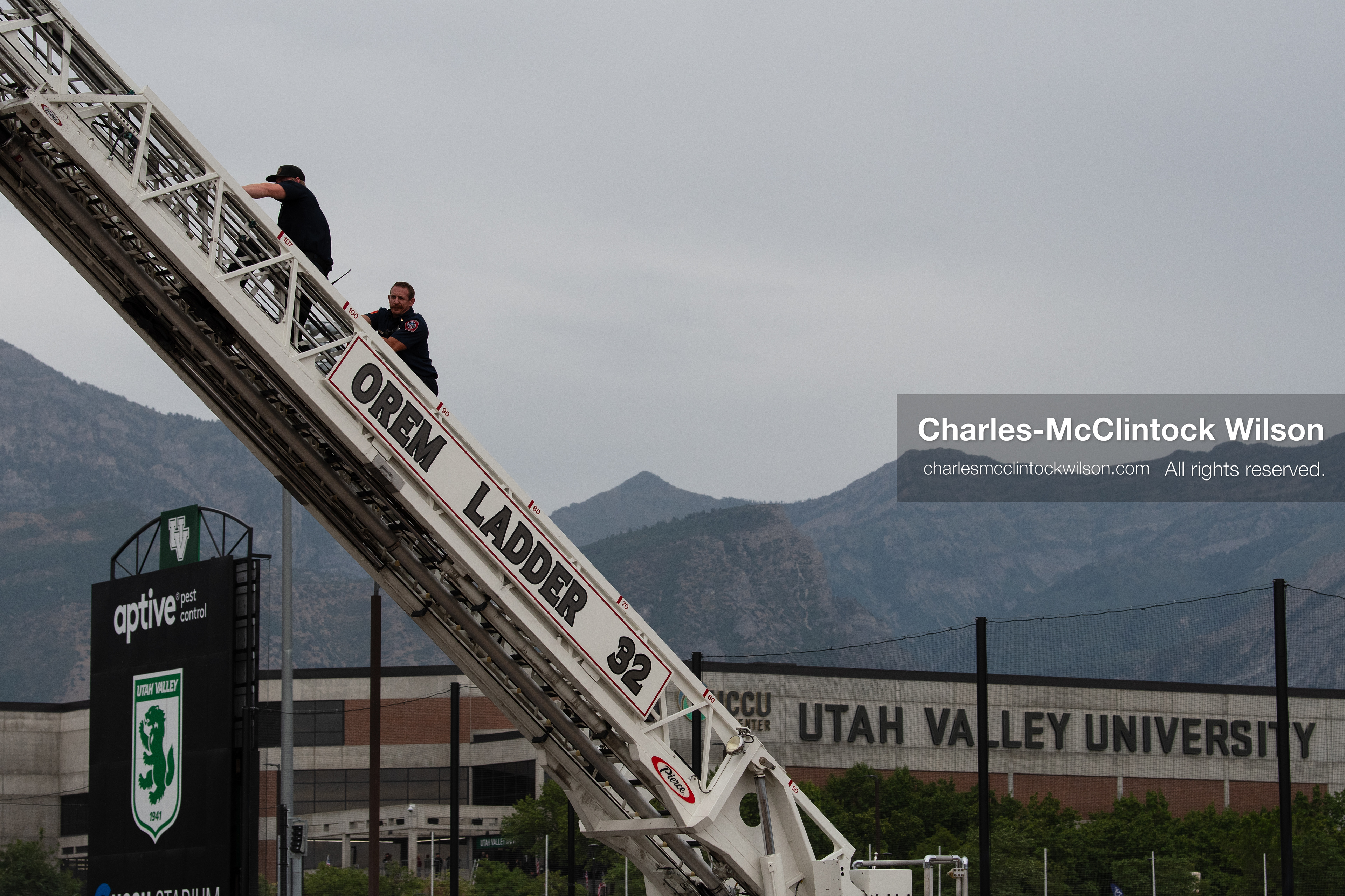 First responders scale an extended Orem Fire Department ladder truck outside the UCCU Center at Utah Valley University in Orem, Utah, on Wednesday, July 29, 2026. More than 300 people came to the public memorial ceremony to honor Provo Fire Captain Spencer Long, his wife Katrina, and three of their sons, who died after a flash flood hit their campsite near the Sunglow Campground in Wayne County. (Photo by Charles-McClintock Wilson/Sipa USA)