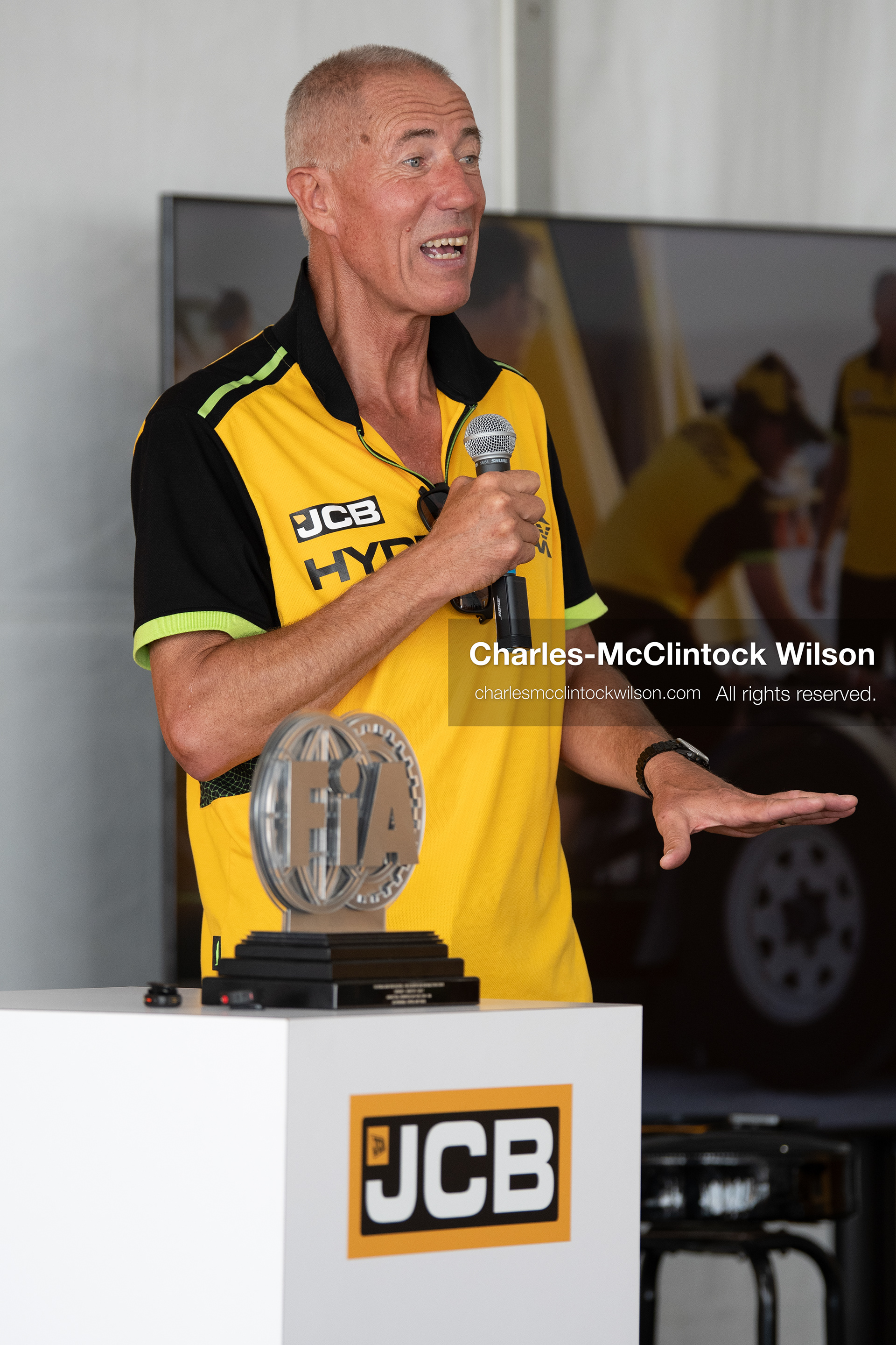 British pilot Andy Green speaks into a microphone during a press conference on the Bonneville Salt Flats on Tuesday. Green steered the hydrogen-powered "JCB Hydromax" streamliner to a historic record-breaking top speed of 406.320 mph during official speed trials. (Photo by Charles-McClintock Wilson/Sipa USA)