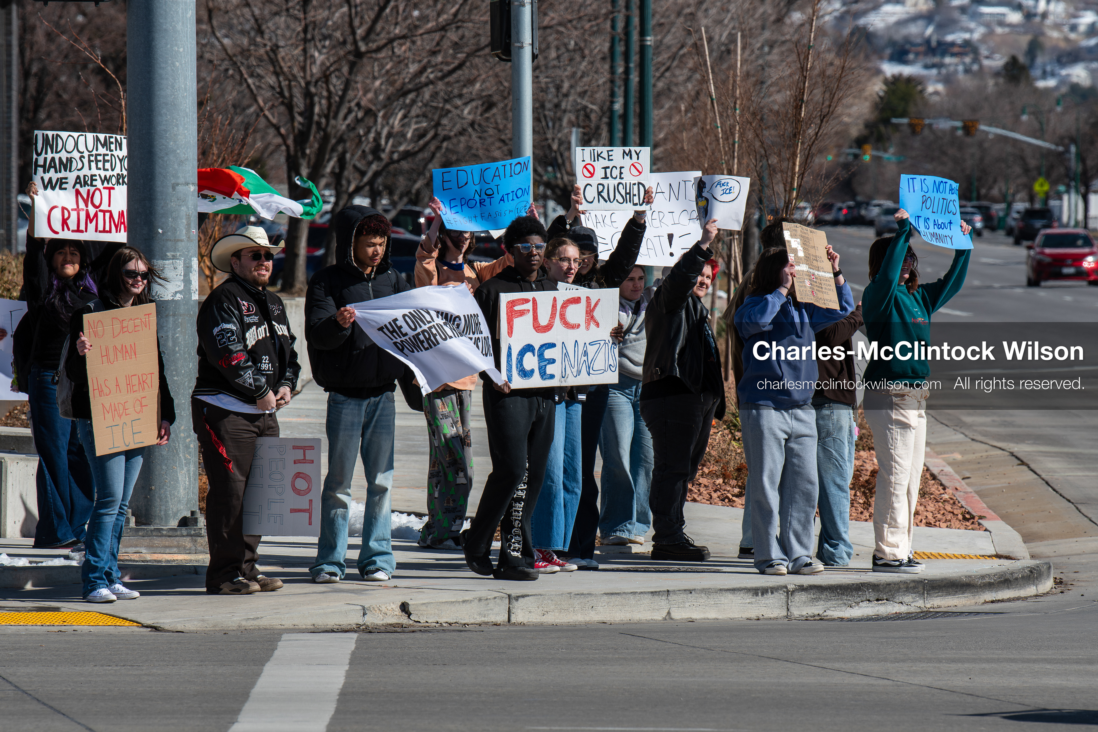 February 20, 2026, Orem, Utah, USA: High school students gather along State Street in front of Orem City Hall during a student led protest against ICE and federal immigration enforcement. Demonstrators hold signs as they stand near the roadway while traffic continues through the area. (Credit Image: © Charles McClintock Wilson/ZUMA Press Wire)