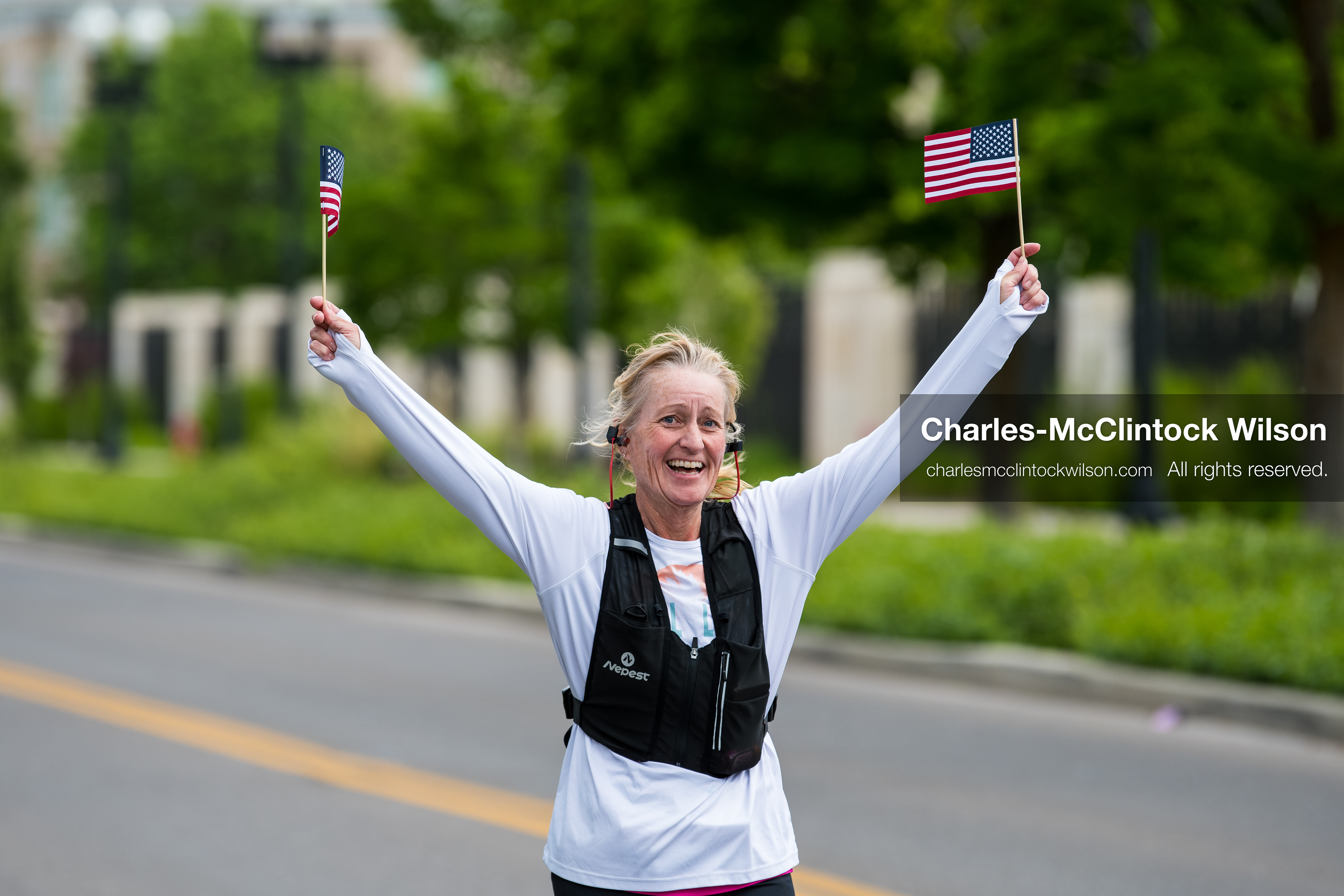 May 16, 2026, Ogden, Utah, USA: A runner waves two small American flags while participating in the 25th Annual America First Ogden Marathon in Ogden, Utah, on Saturday, May 16, 2026. The event marked the 25th running of the marathon, drawing thousands of participants and spectators. (Credit Image: © Charles-McClintock Wilson/ZUMA Press Wire)