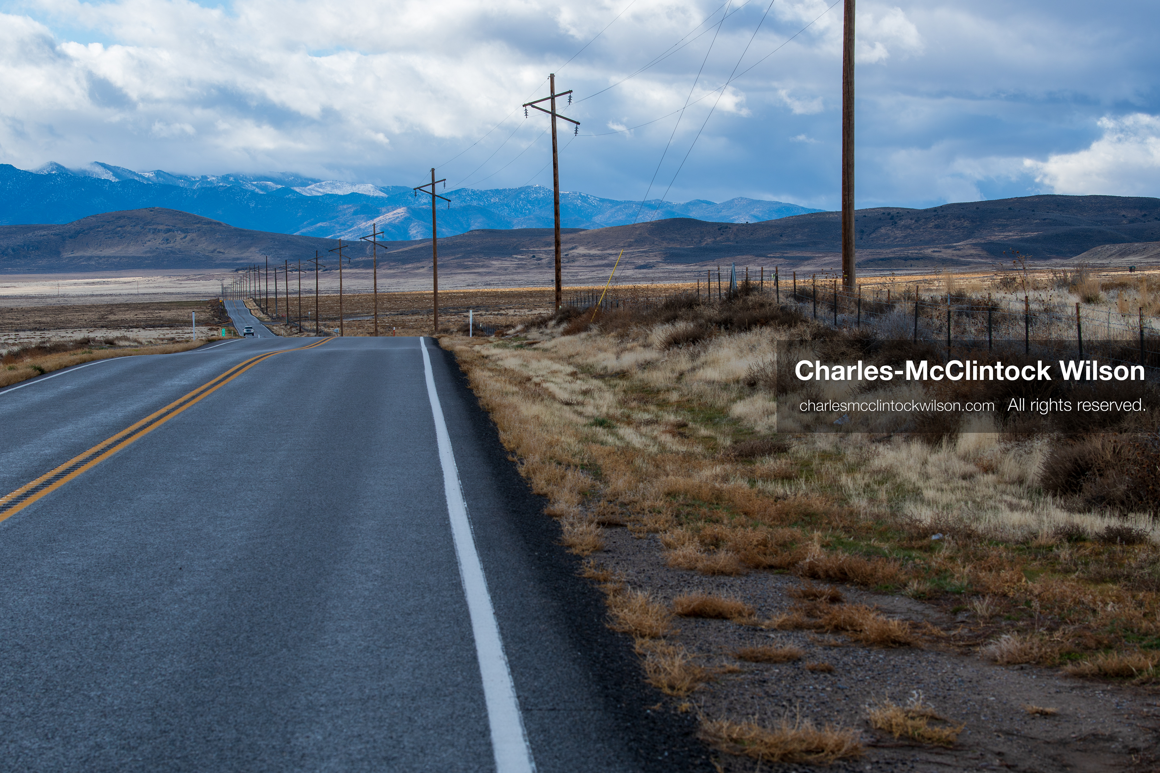 January 1, 2026, Saratoga Springs, Utah, USA: A rural road stretches toward distant mountains on January 1, 2026, near Saratoga Springs, Utah, USA. Utility poles line the route as dry grass and open plains frame the landscape under partly cloudy skies. (Credit Image: © Charles-McClintock Wilson/ZUMA Press Wire)